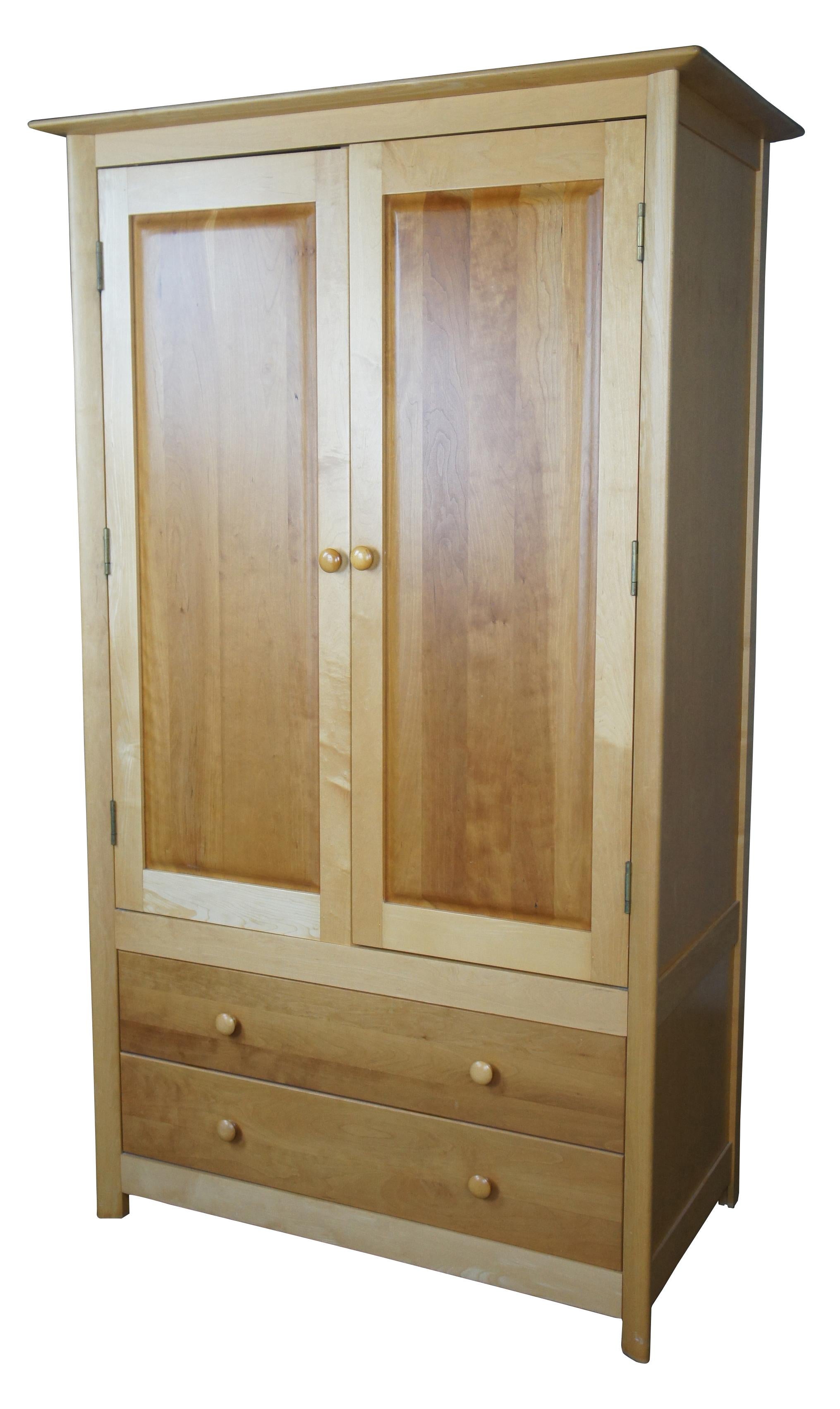 Copeland Furniture Sarah Maple & Cherry Shaker Armoire Entertainment cabinet

The armoire/entertainment center features bi-fold doors, two adjustable shelves, a removable hanging rod and two access holes for media connections. The back of the