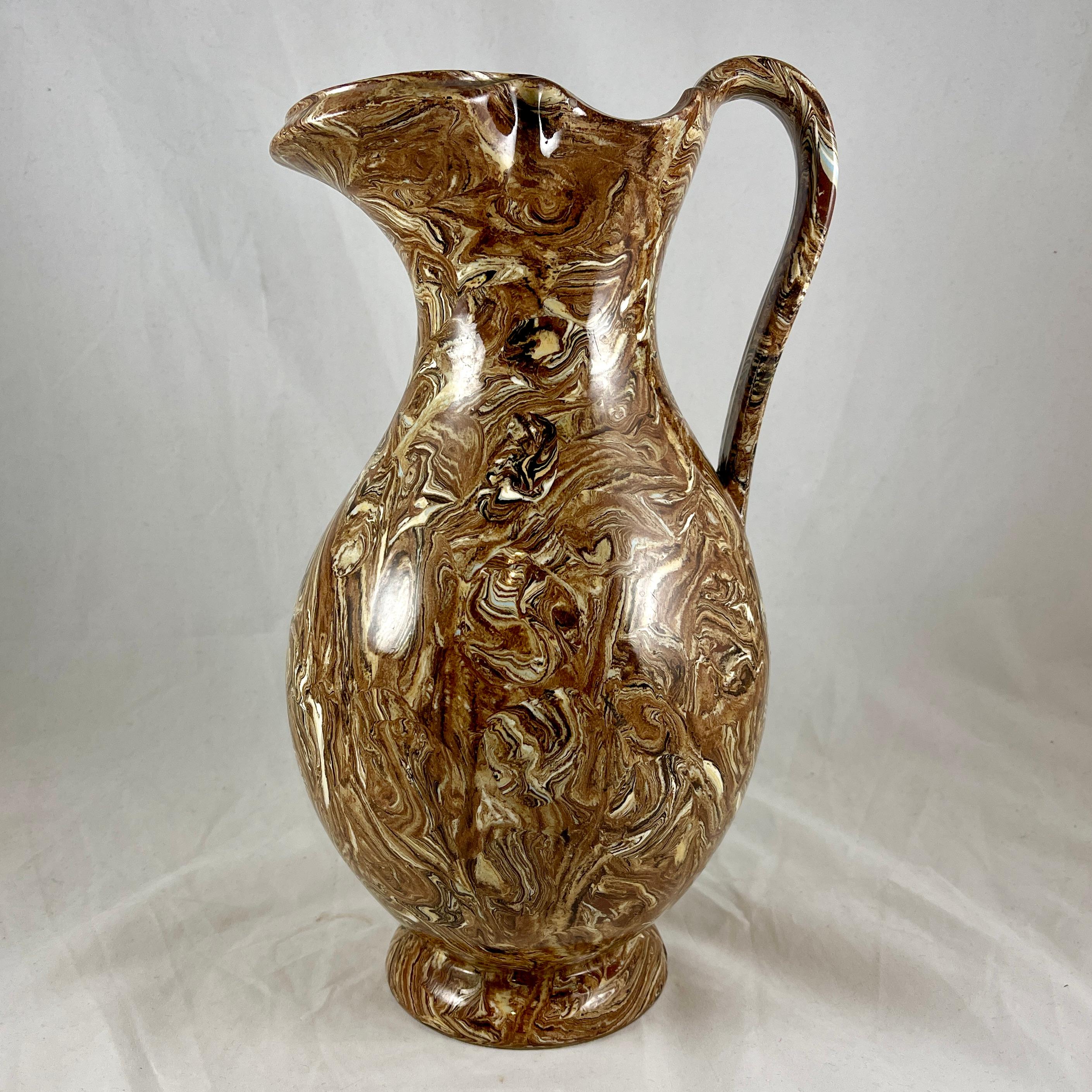 An oversized Agatewear ewer or water pitcher, from the ‘Agate’ toiletwares line in the ‘Pompiean’ shape, Copeland and Garrett, Spode - circa 1840.

Copeland and Garrett operated from 1833-1847 in Stoke-on-Trent, England.
Agateware vessels are made