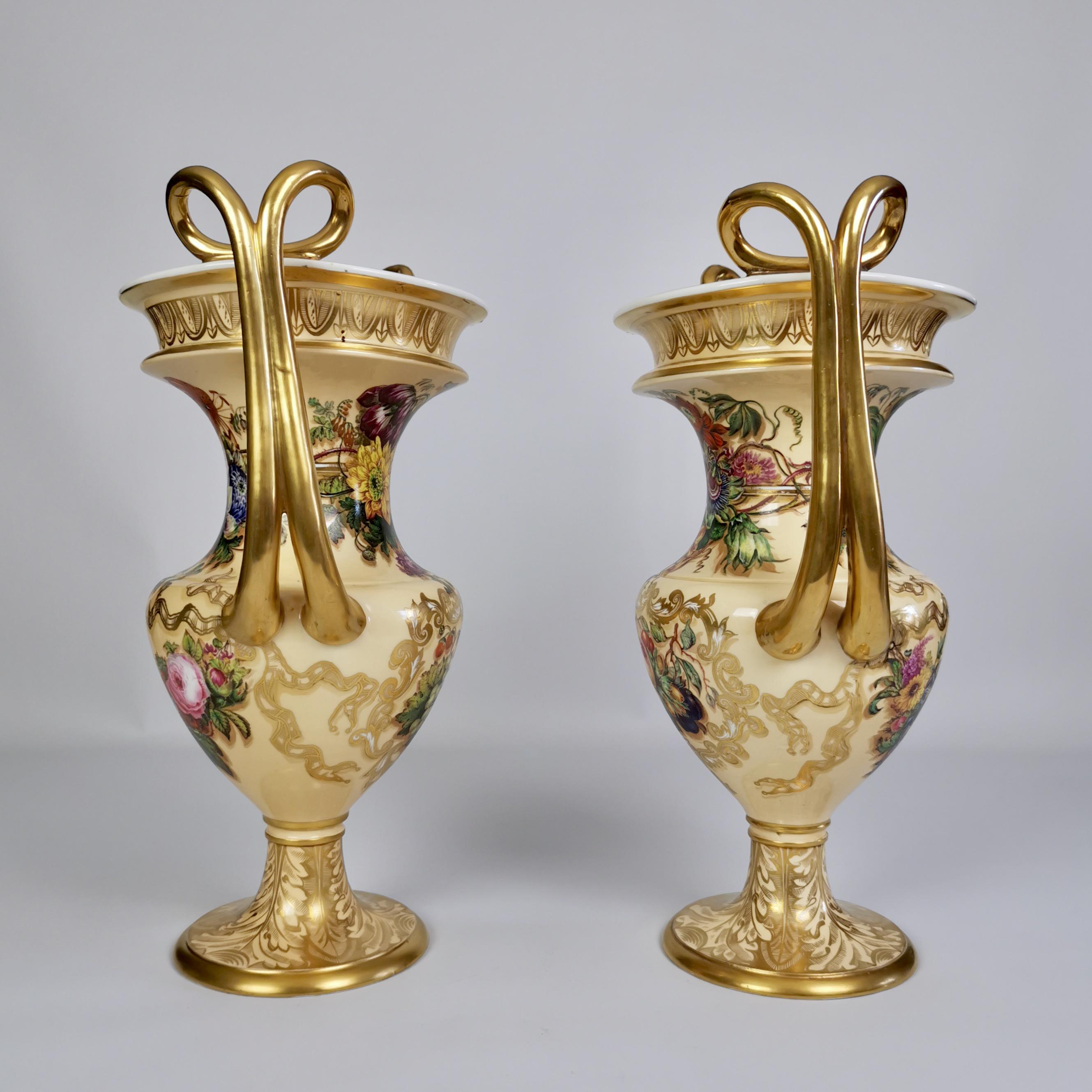 On offer is an extremely rare and sublimely crafted pair of vases made by Copeland & Garrett between 1833 and 1847, which was the Rococo Revival era. The vases have a soft yellow ground with lavish gilding and stunning paintings of flowers and