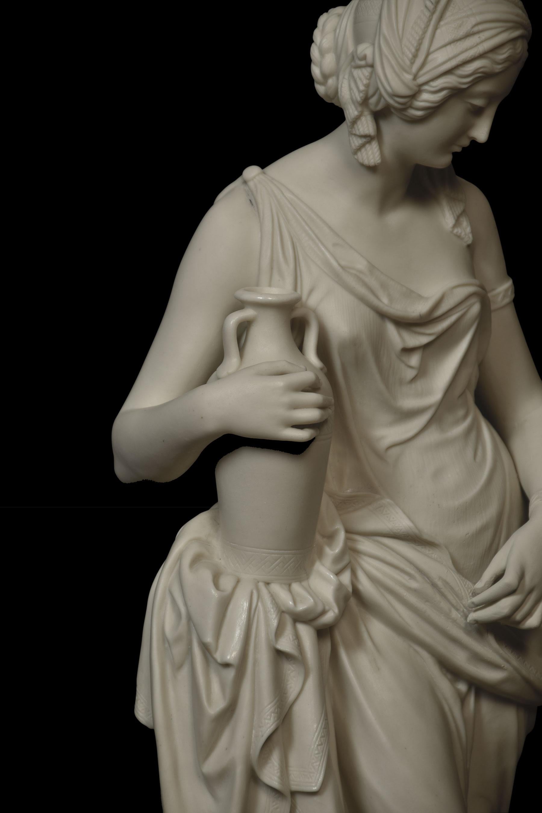 Opeland parian figure of Rebekah after William Theed, standing full length by a palm, wearing flowing robes with her right hand resting on an amphora. raised up on circular base.
Dimensions:
height 20 inches.
width 8 inches.
depth 8 inches.
