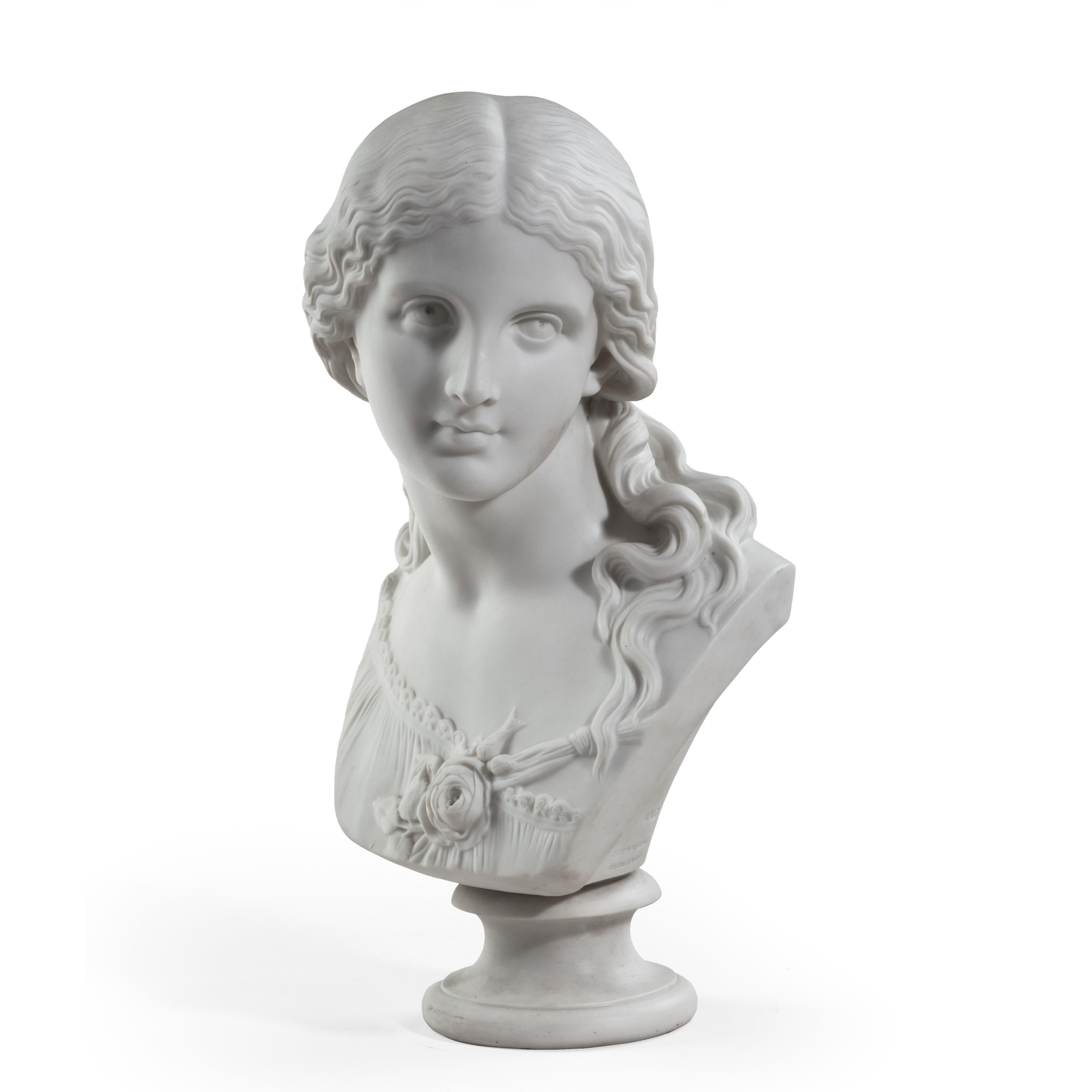 An attractive Copeland Parian ware bust of “Love” by Raffaelle Monti, dated 1871, showing a girl with her head turned to the left and tendrils of hair falling over her left shoulder, with a rose spray tied across her bodice, the reverse stamped ‘R