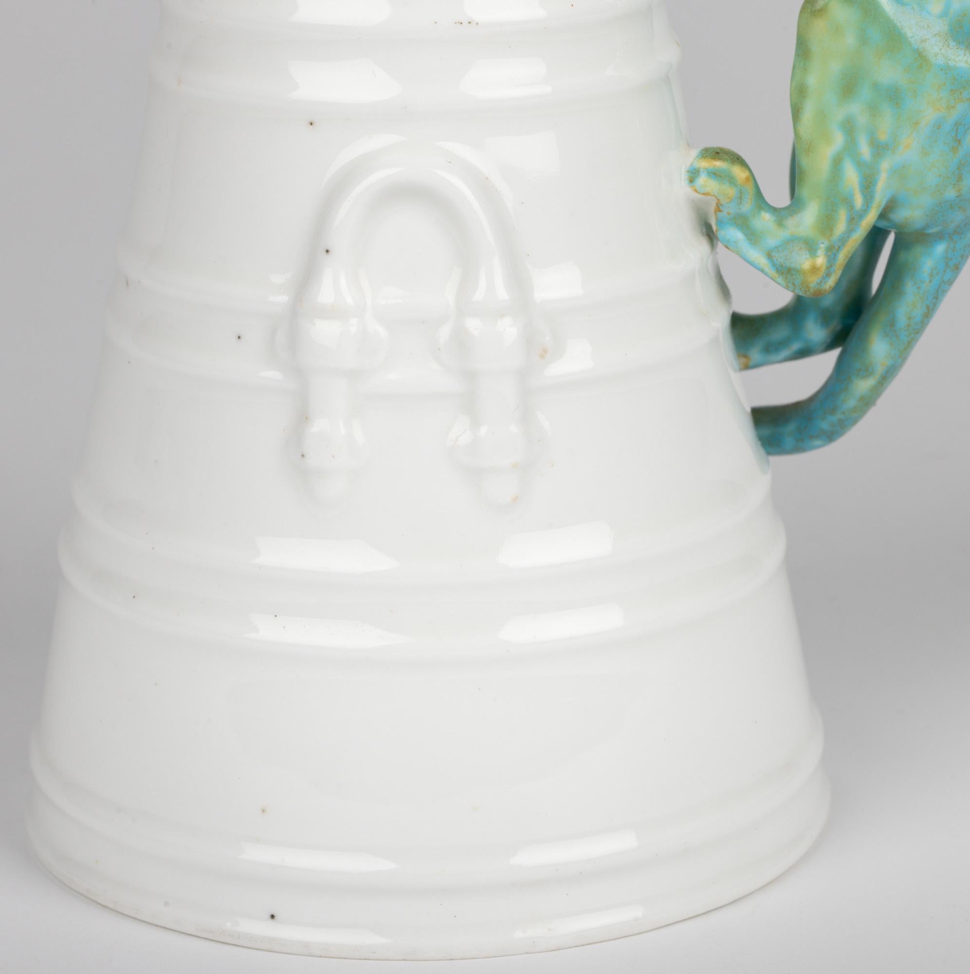 A delightful and scare antique English porcelain vase modelled as a cat looking into a cream or milk churn made by renowned makers Copeland and dating from the 19th century. The vase is formed as a funnel with a wide rounded unglazed foot with