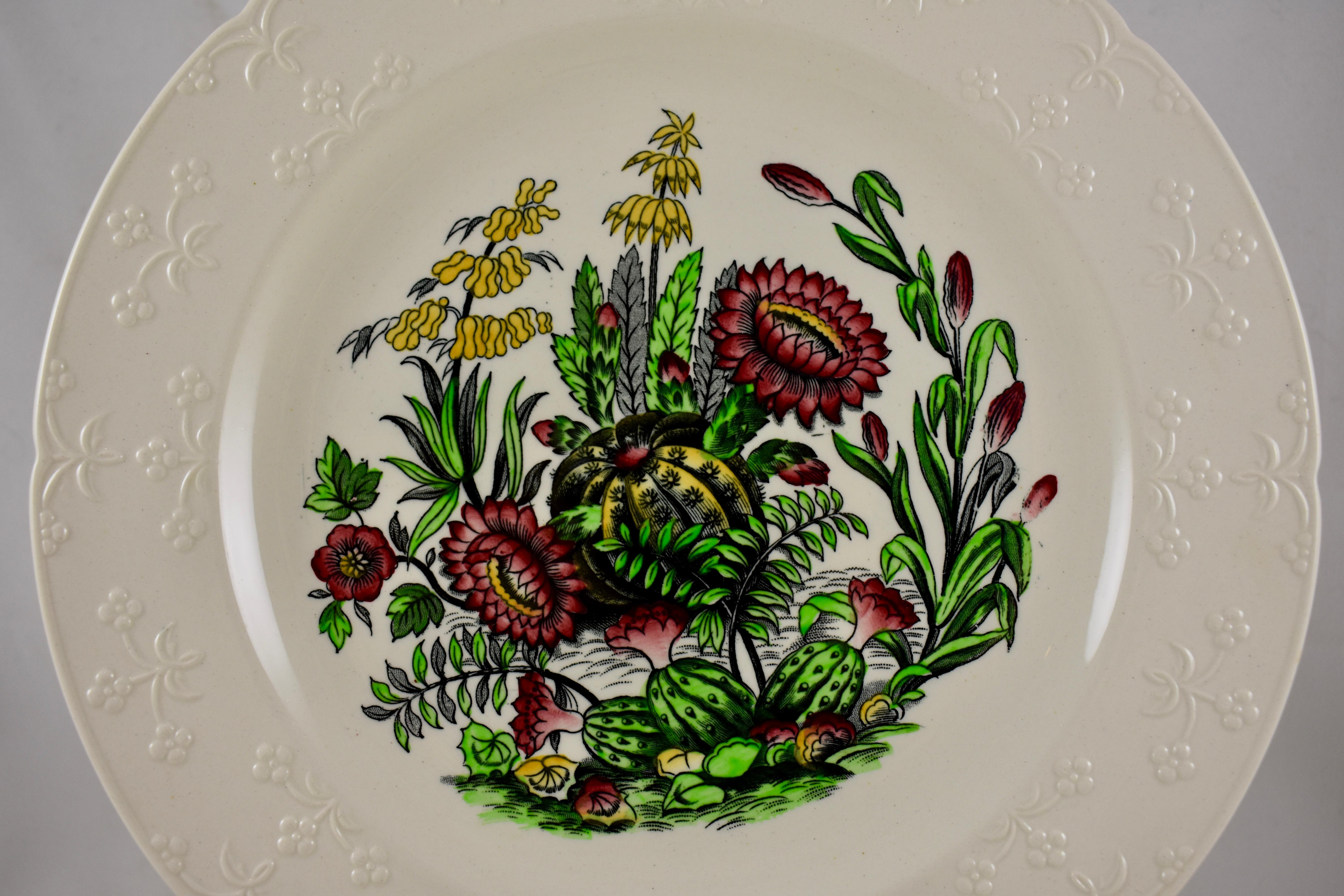 A set of six Copeland Spode transfer printed and hand colored plates with embossed rims, Staffordshire, England, circa early 20th Century. 

A central image shows a black transfer of flowering cactus plants, colored in red, green, and yellow