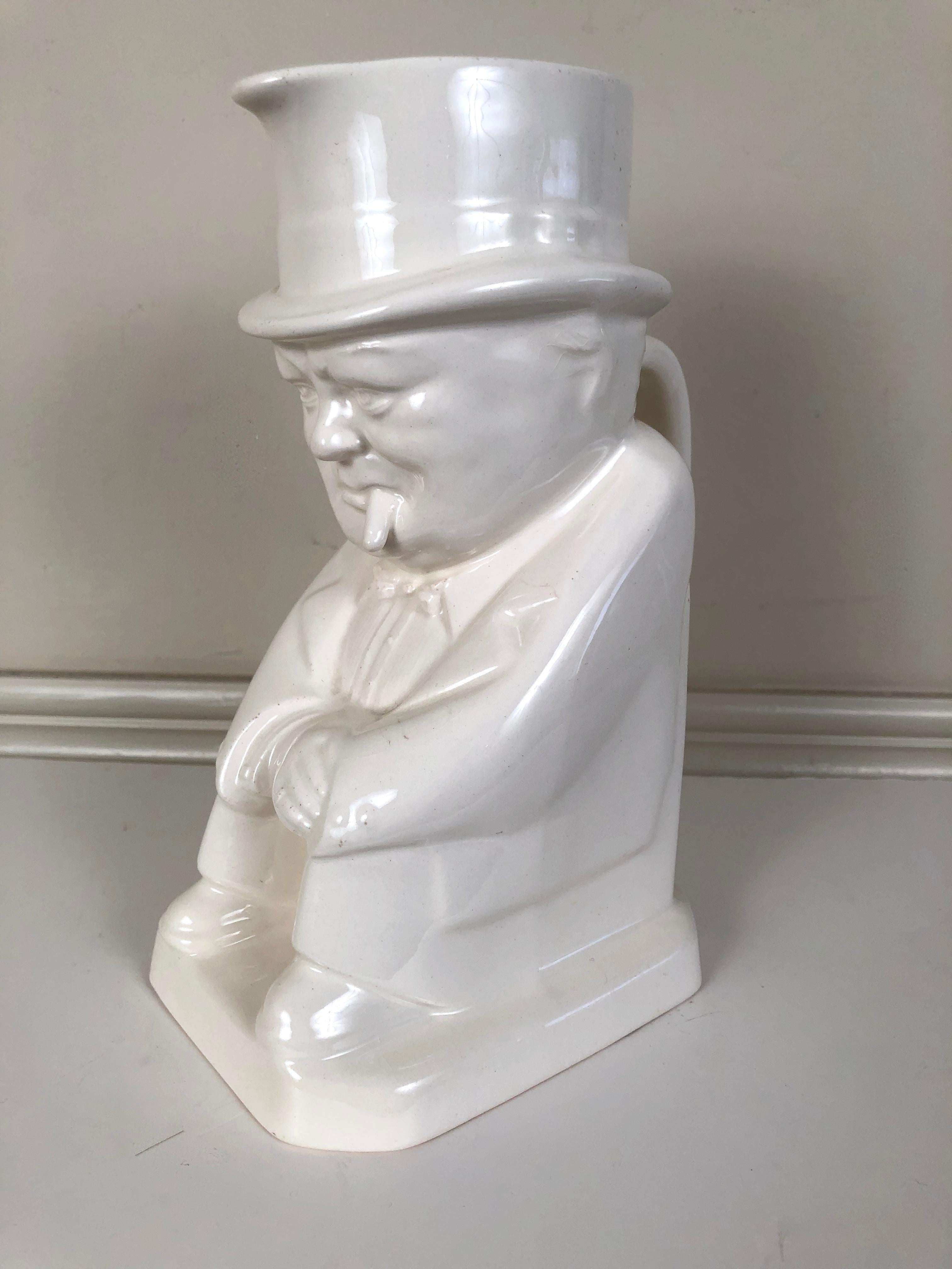 A blanc de chine white ceramic pottery pitcher (or Toby jug) of Sir Winston Churchill designed by Eric Olsen for Spode, the spout issuing from Churchill's signature top hat, his face expressively modeled, replete with his omnipresent cigar.