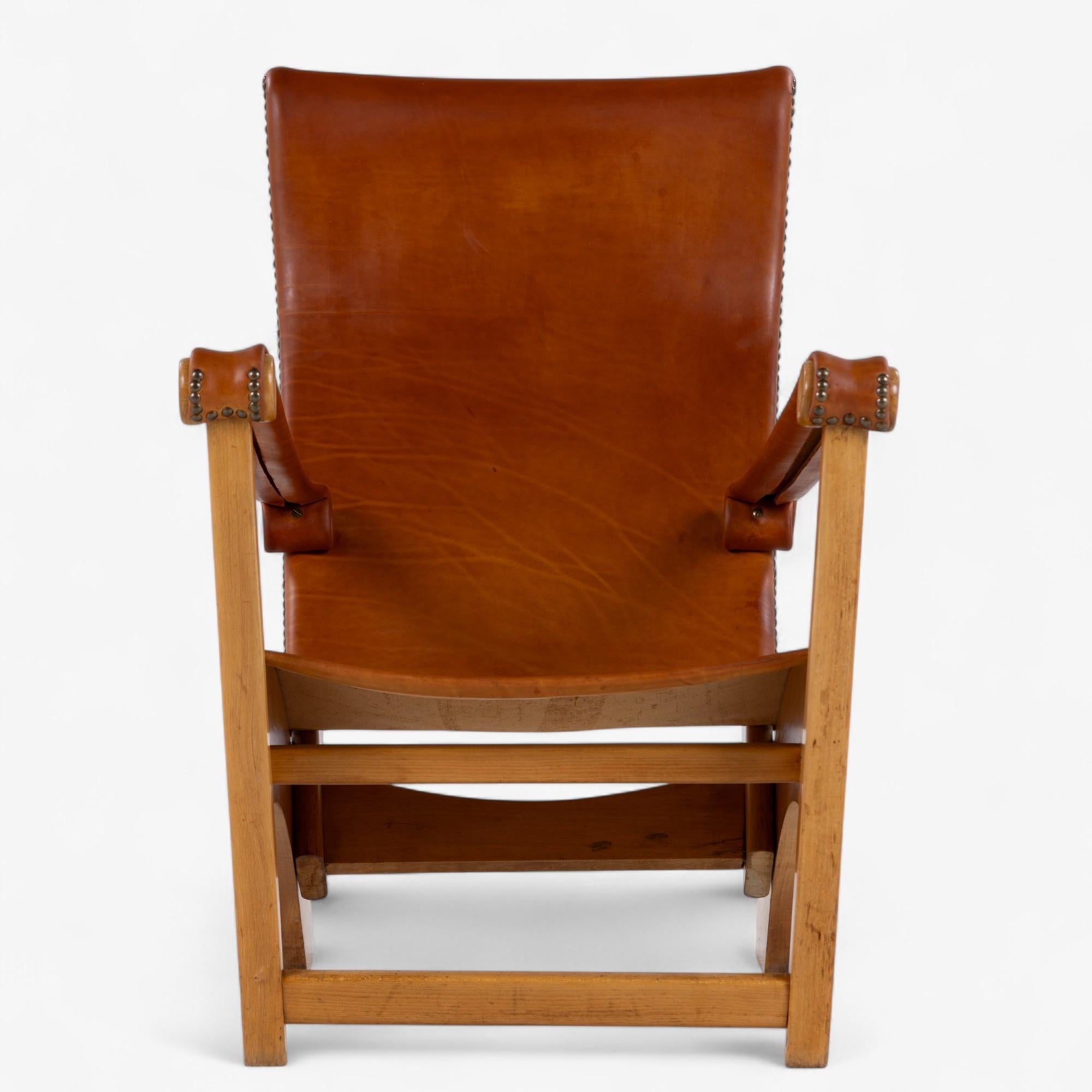 'Copenhagen' easy chair in patinated natural leather with frame in oak. Designed by Mogens Voltelen and mady by Niels Vodder.