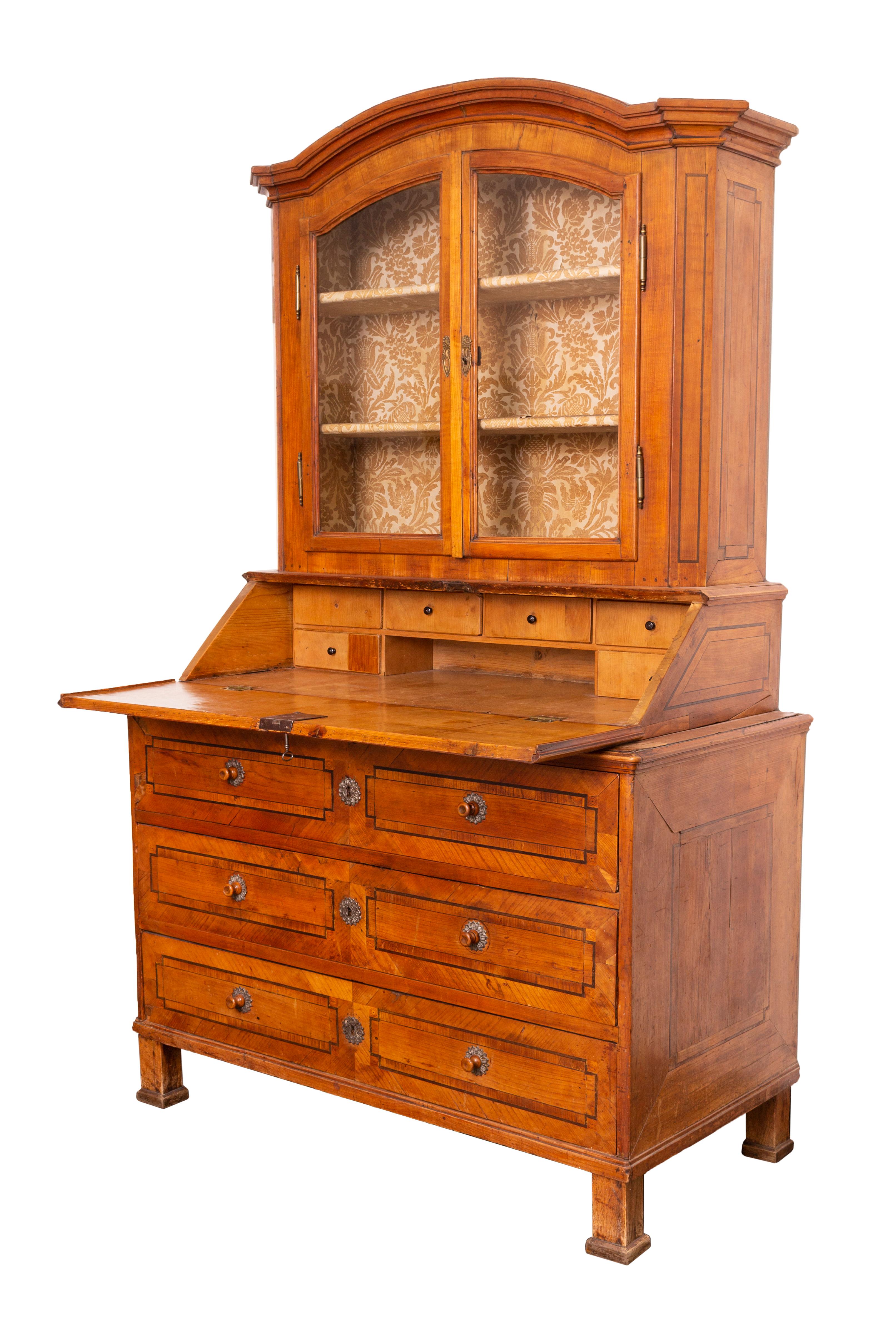 Early 19th century hutch, (combination of a writing secretaire and a glass cabinet) in Copf-Style. The pine corpus has a cherry veneer, and has fine wooden inlay decoration.

Copf-Style - or in German Zopfstil - markes a stylistic period between