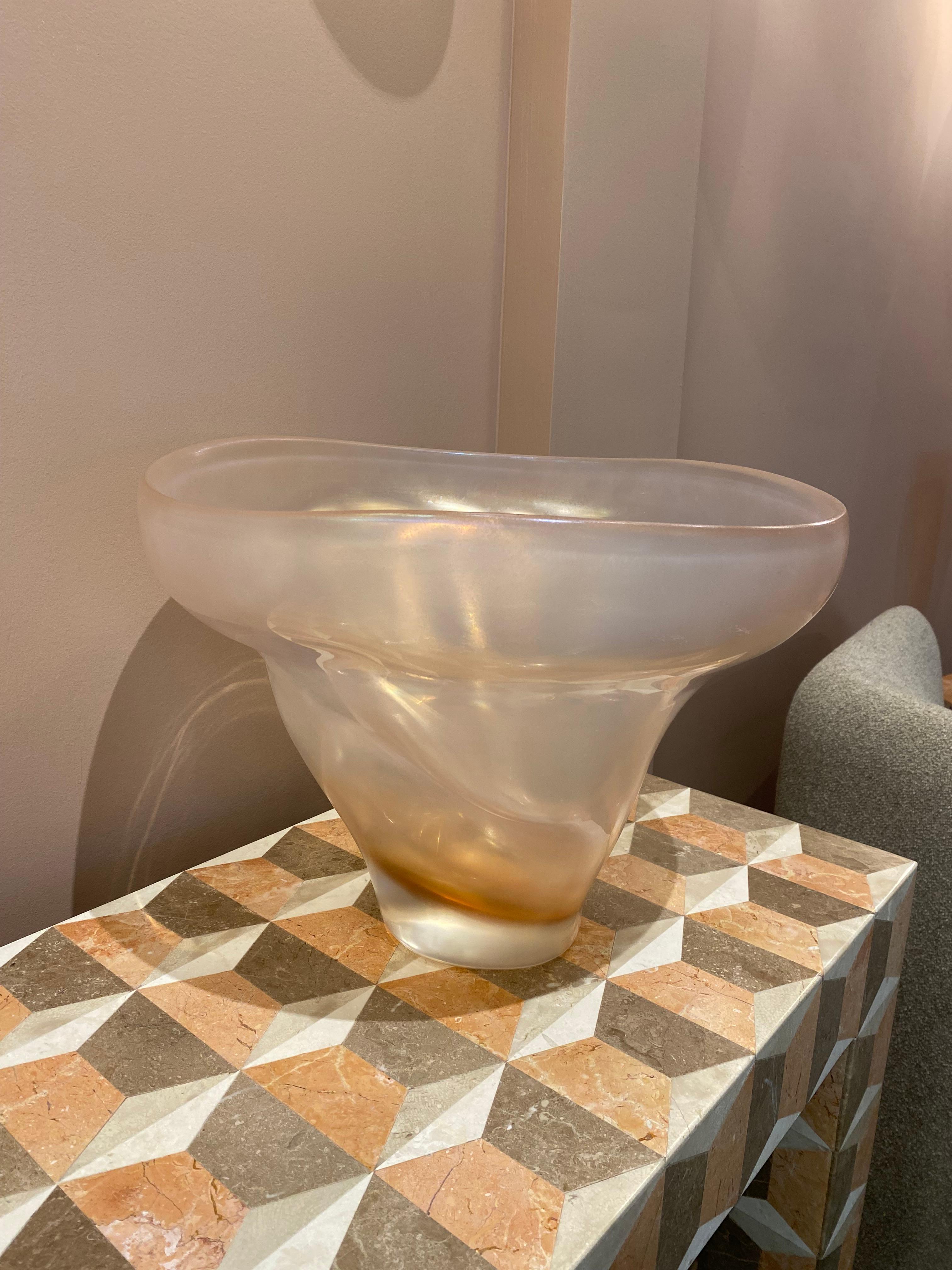 The process of Iridazione (to make a surface iridescent) gives to the glass a visual pearl-like effect. This chemical process is generated when the glass is still soft and incandescent.

Dimensions: 

Rose 31 x 41 cm

Material: Glass

 Artisan: 