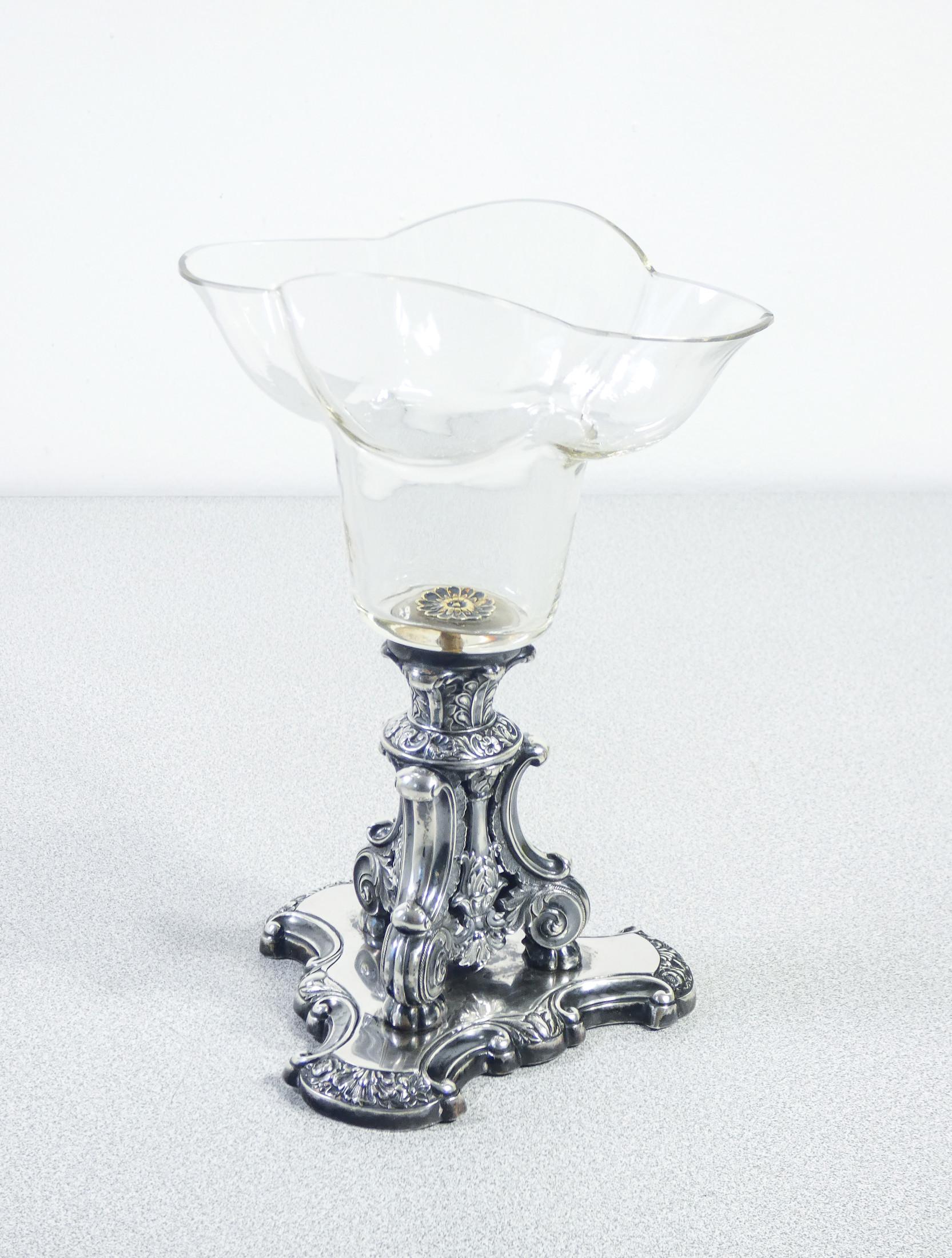 Silver cup
and glass by Johann H.P.
SCHOTT Söhne.

ORIGIN
Germany

PERIOD
1840 ca

AUTHOR
Silversmith Johann H.P.
SCHOTT Söhne

MODEL
Cup, vase

MATERIALS
Silver and glass

DIMENSIONS
Height: 22.5cm
Width: 16.2cm
Depth (Ø base): 12
