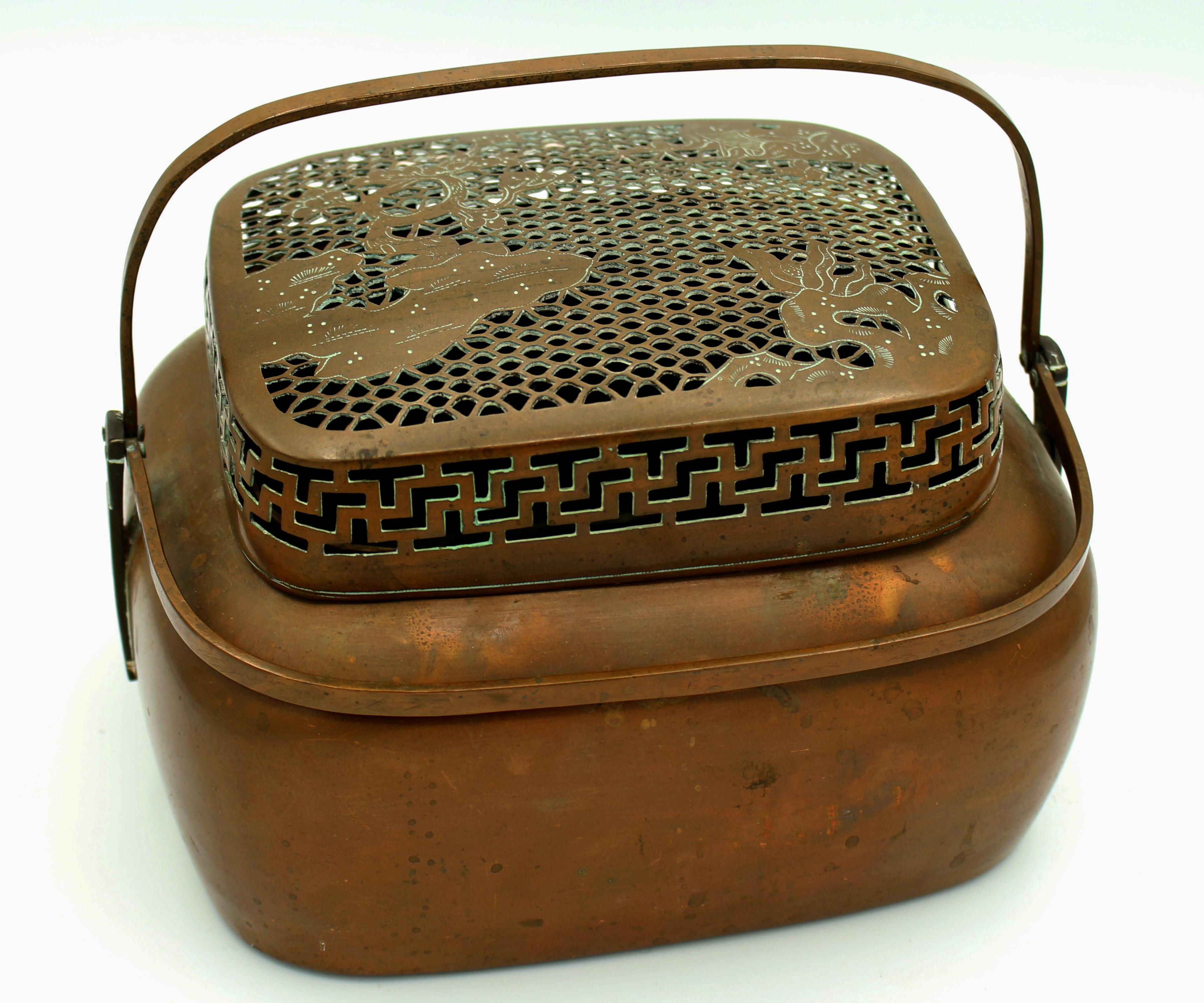 A fine 19th century Chinese cricket box basket. Copper with double swing handles. The cutwork top with Greek key motif border and top panel with landscape featuring a cherry blossom tree. A charming piece! Also useful for potpourri, yarn, etc. etc.