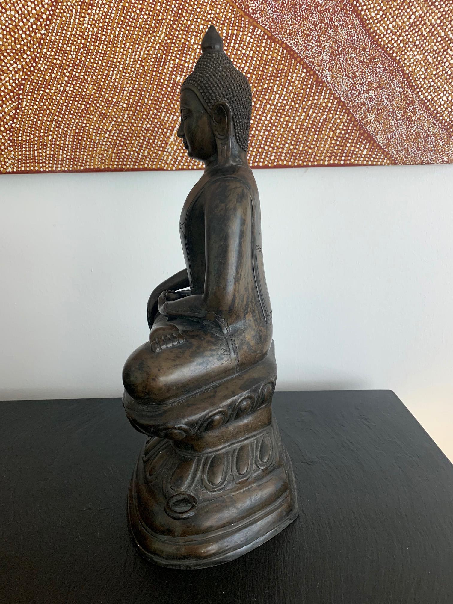 A statue of Medicine Buddha on double lotus throne cast in copper alloy in lost wax technique. Medicine Buddha is also known as Bhaisajyaguru, the Buddha of medical healing prowess, who is highly revered in Mahayana Buddhism. He is often depicted as