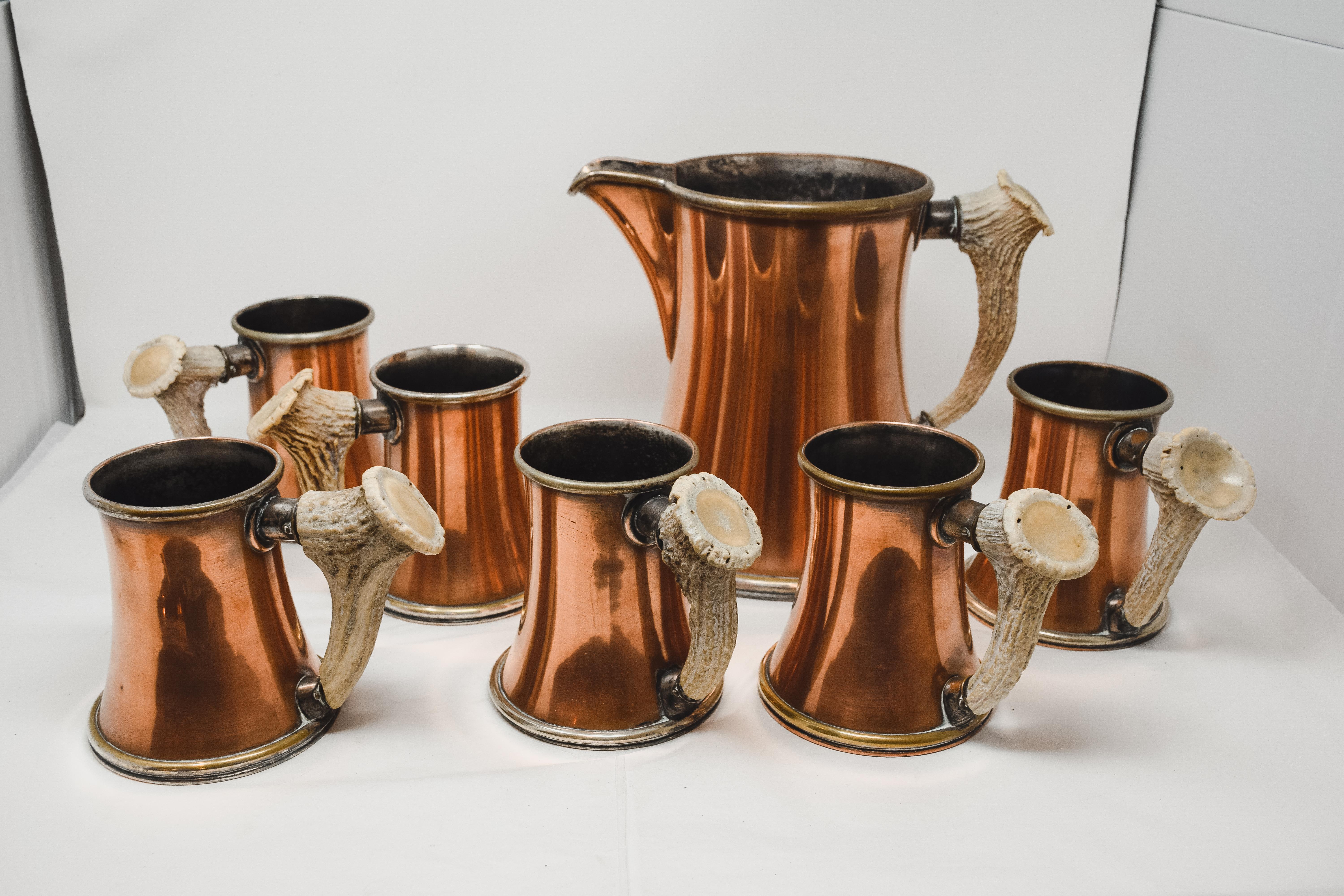 Enjoy Octoberfest with this beautiful Copper and Antler Pitcher and accompanying set of 6 mugs. Perfect for the at home bartender to create the most amazing Moscow Mule. This unique service includes a pitcher and 6 mugs. Made of Copper and Antler