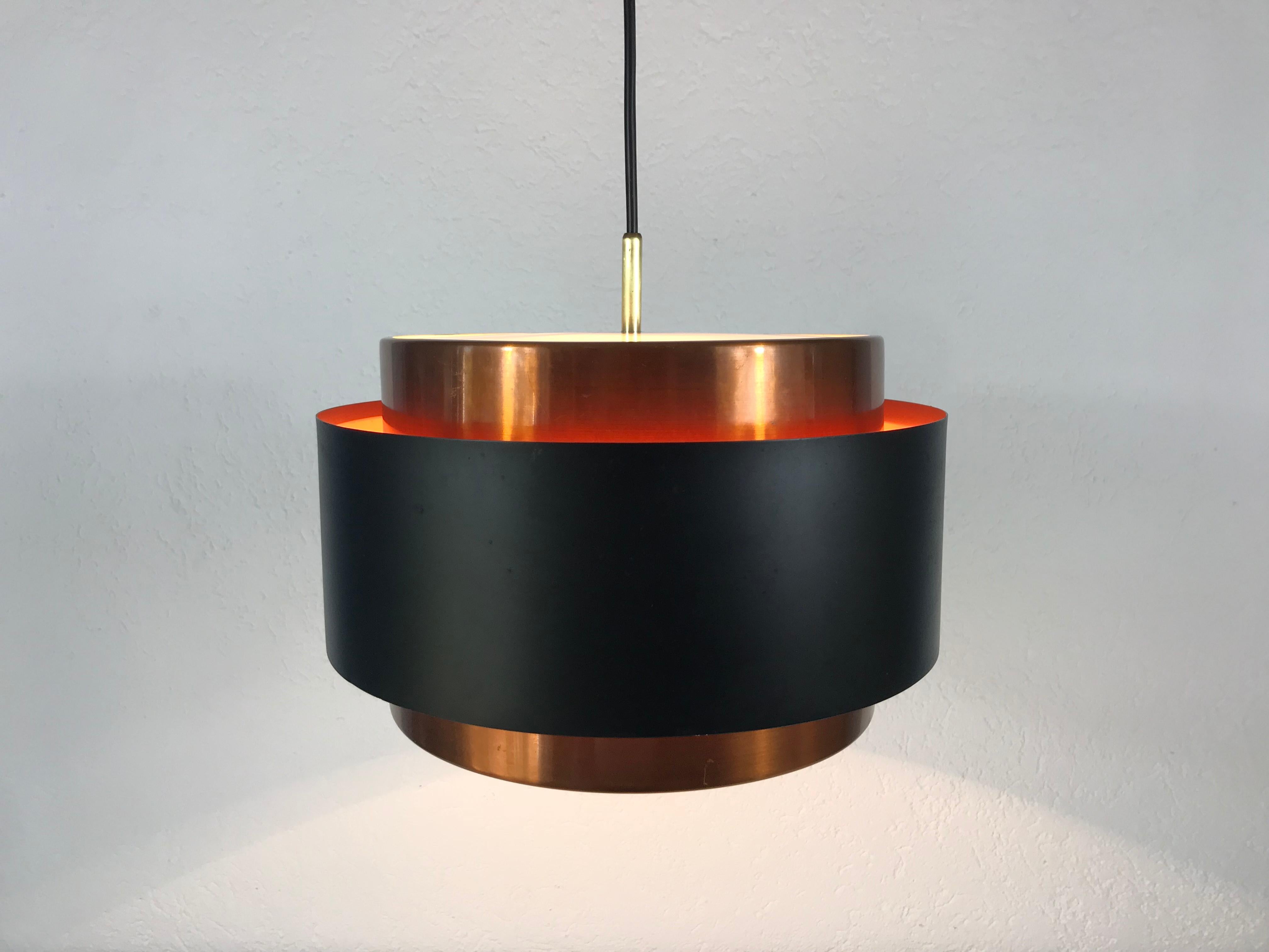 Black and copper pendant lamp by Fog and Mørup made in Denmark in the 1960s. The fixture gives a very beautiful light. It is made from thin aluminum and copper.

The light requires one E27 light bulb.
 