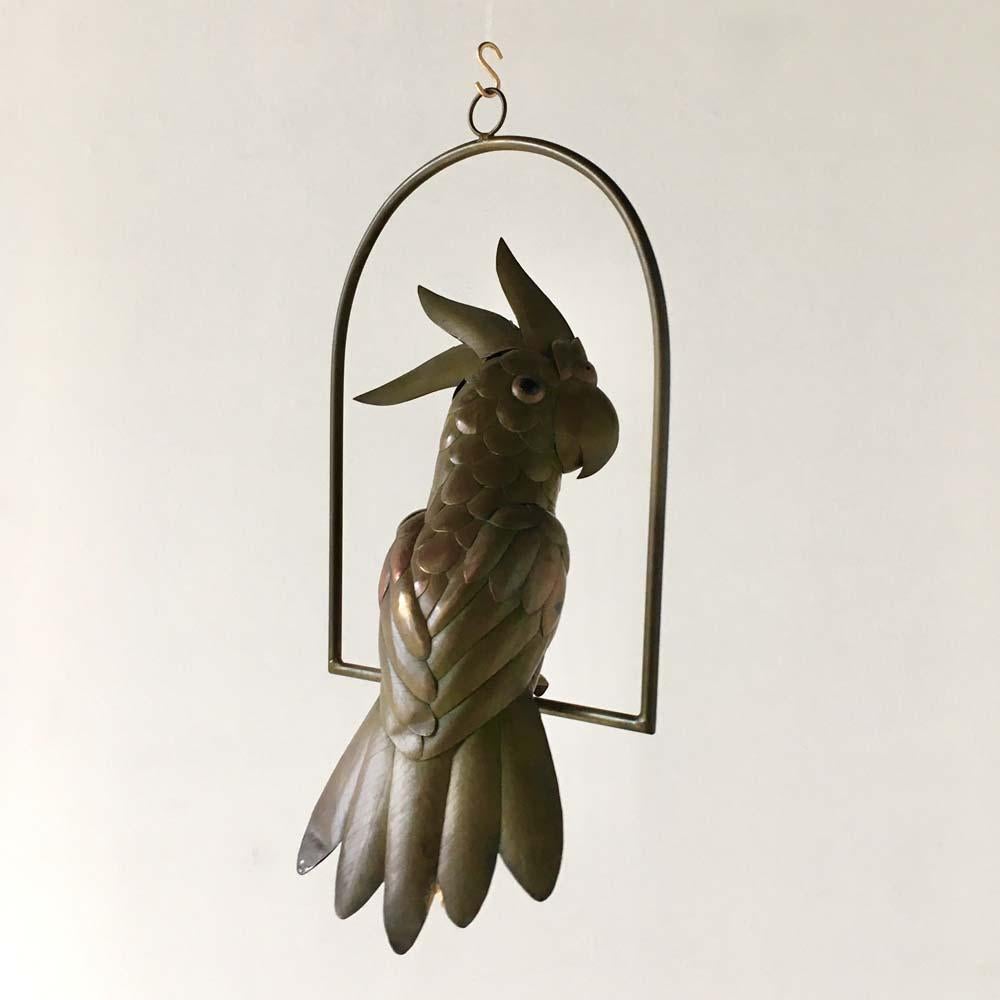Copper and brass cockatoo on an arch hanging stand by Sergio Bustamante, 1960s. 

Sergio Bustamante is a Mexican artist and sculptor. He began with paintings and papier mache figures, inaugurating the first exhibit of his works at the Galeria