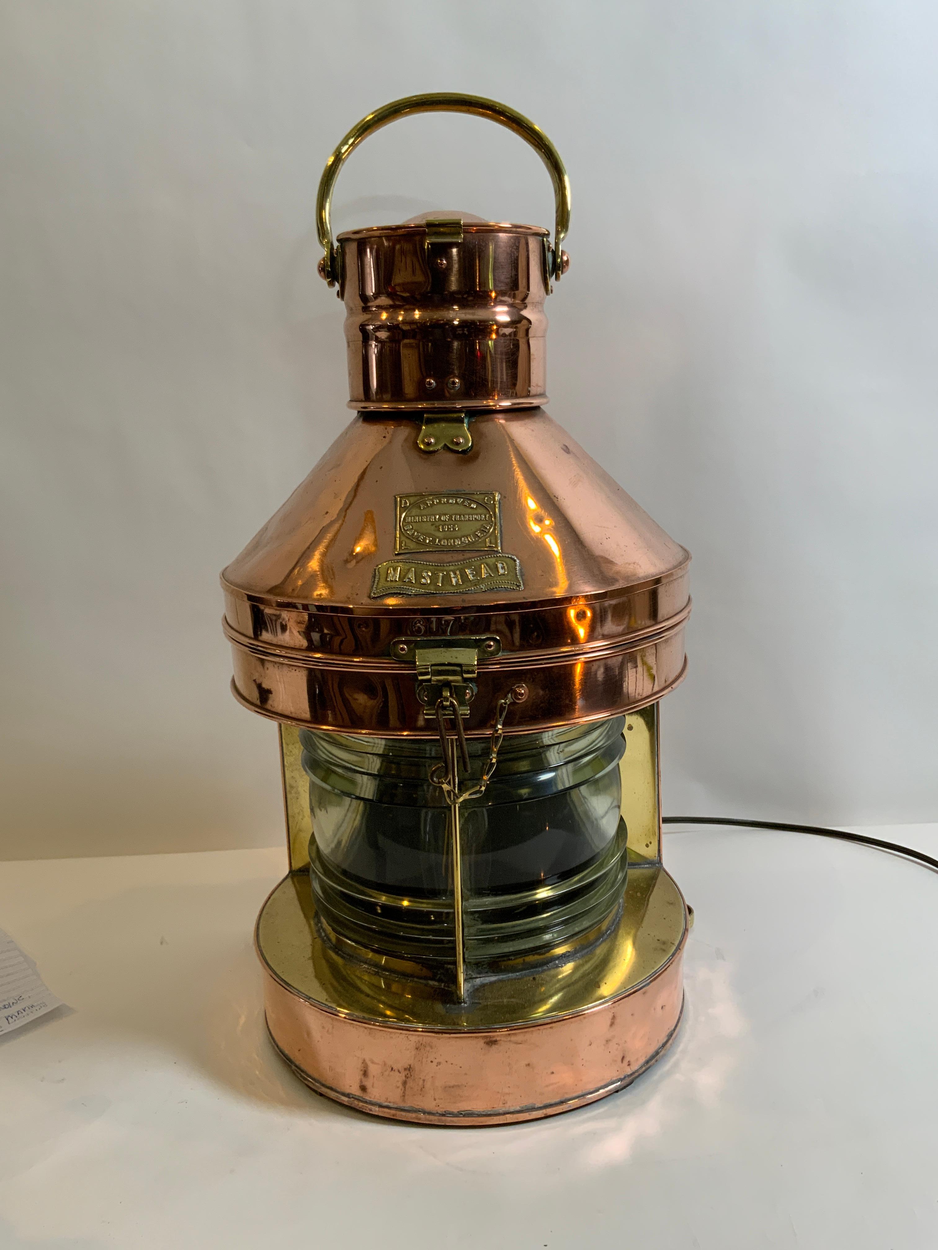Highly polished copper ships lantern by Davey of London. Approved by the ministry of transport. Hinged top. Electrified for home use. Fresnel glass lenses. Heavy carry handle. Outstanding. Circa 1954. Davey is a venerable lantern maker, building
