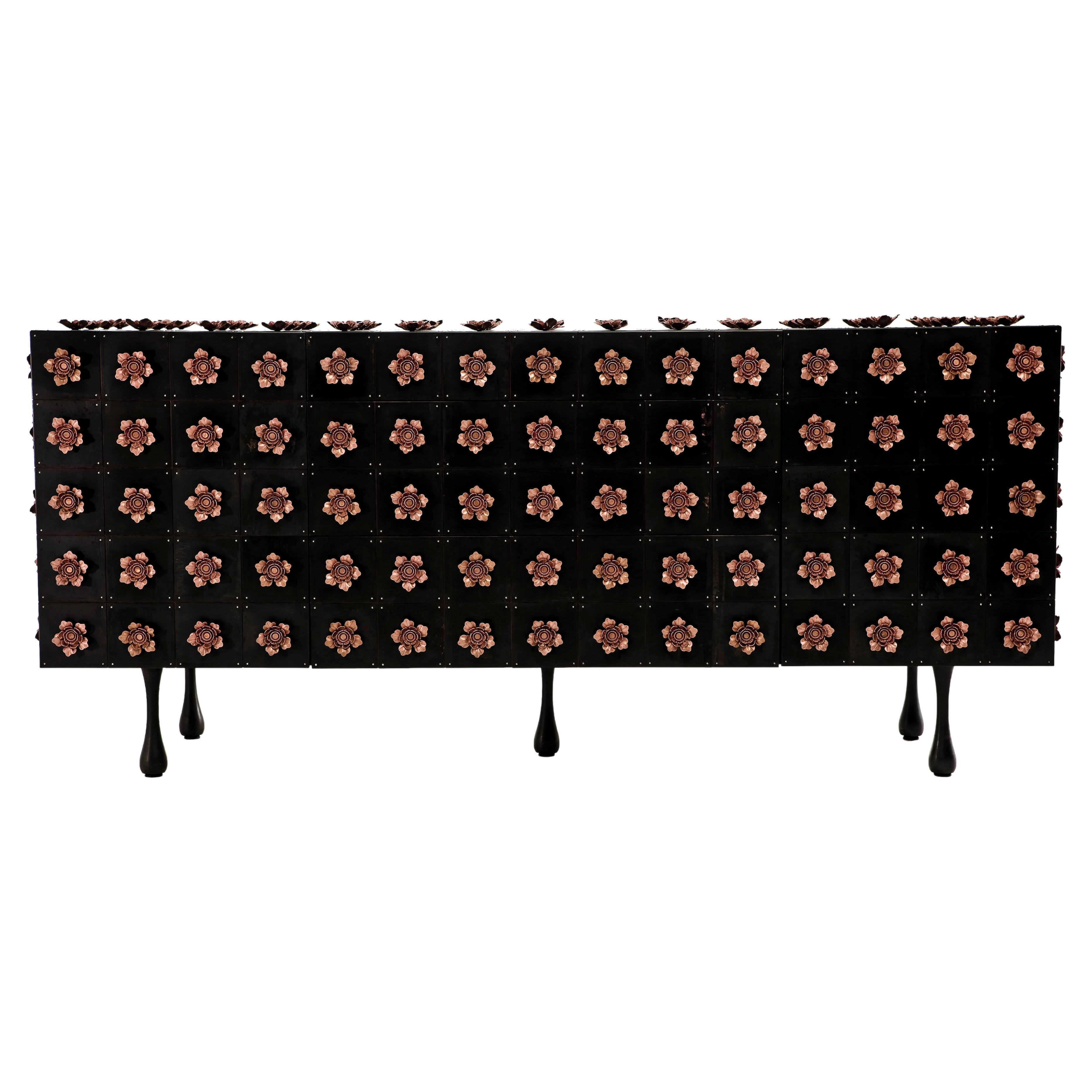 The Rosette sideboard belongs to the Rosette collection designed by Egg Designs and manufactured in South Africa.
This high end, contemporary and bespoke server is covered with a riot of copper steel flowers, these flowers surround the entire piece