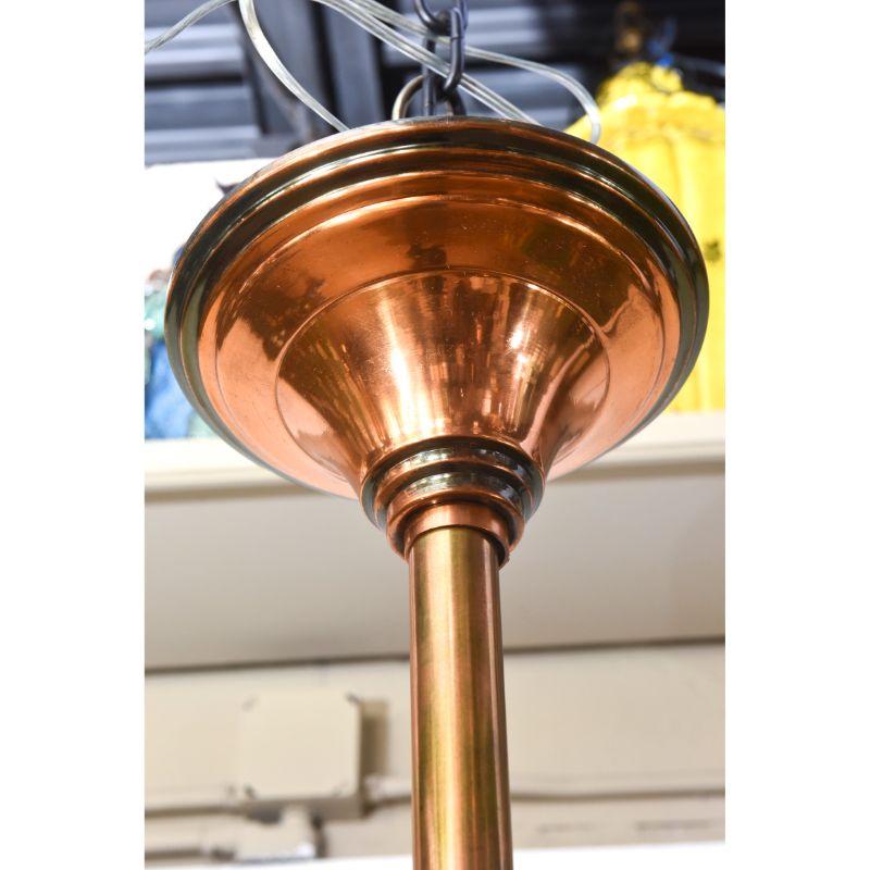 French Deco Pendant Attributed to Petitot. Pendant shape. Lower tier has a copper rim with a frosted cast glass dish with two lights. Two more lights face up from the dish lighting the copper stem and ostrich feather like frosted cast glass