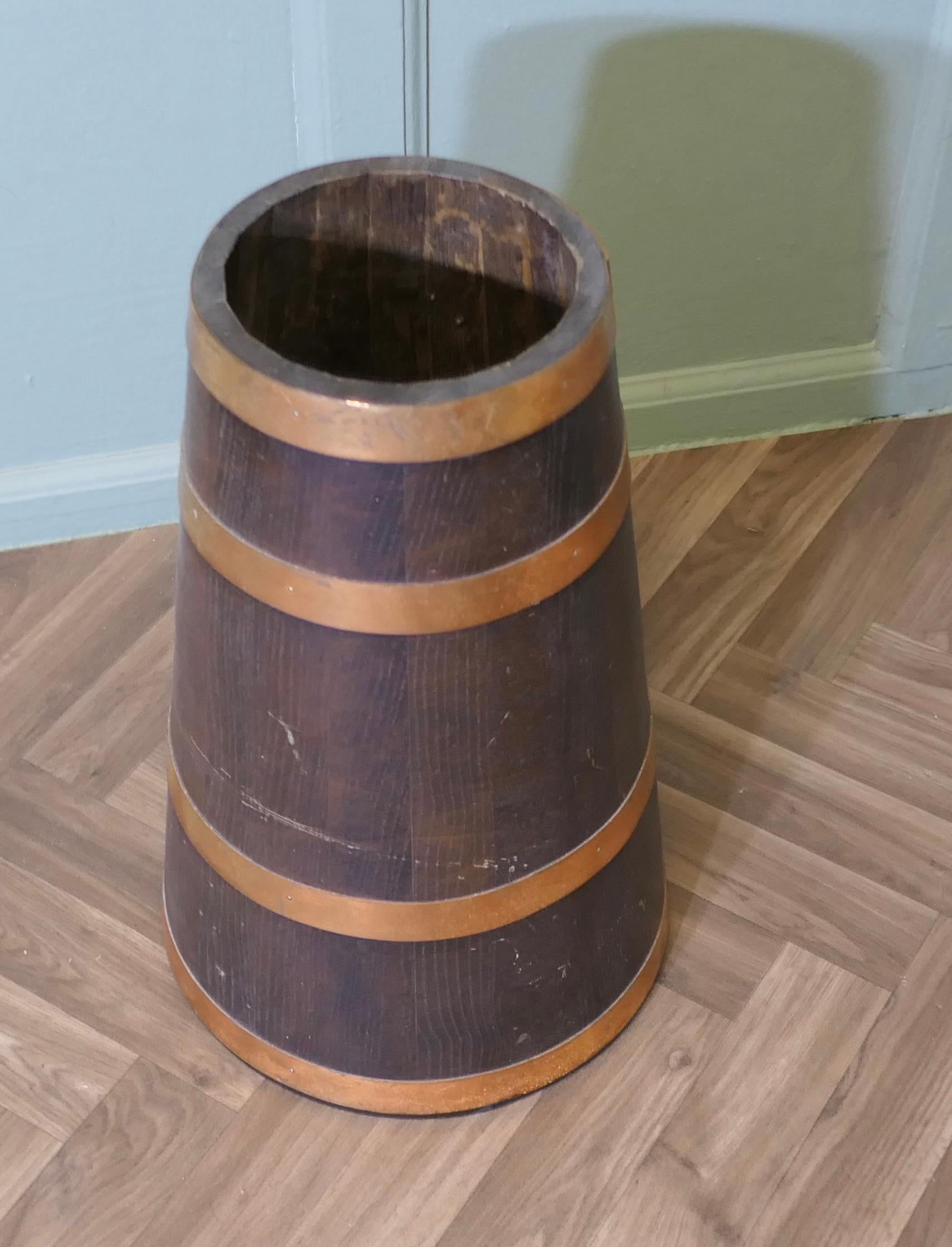 Copper and Oak Barrel Stick Stand

This  good looking piece is cone shaped and heavy at the bottom so very sturdy, it is made with oak staves and bound with 4 wide copper hoops

The Stick stand is in excellent condition, it is 19” high and 12”  in