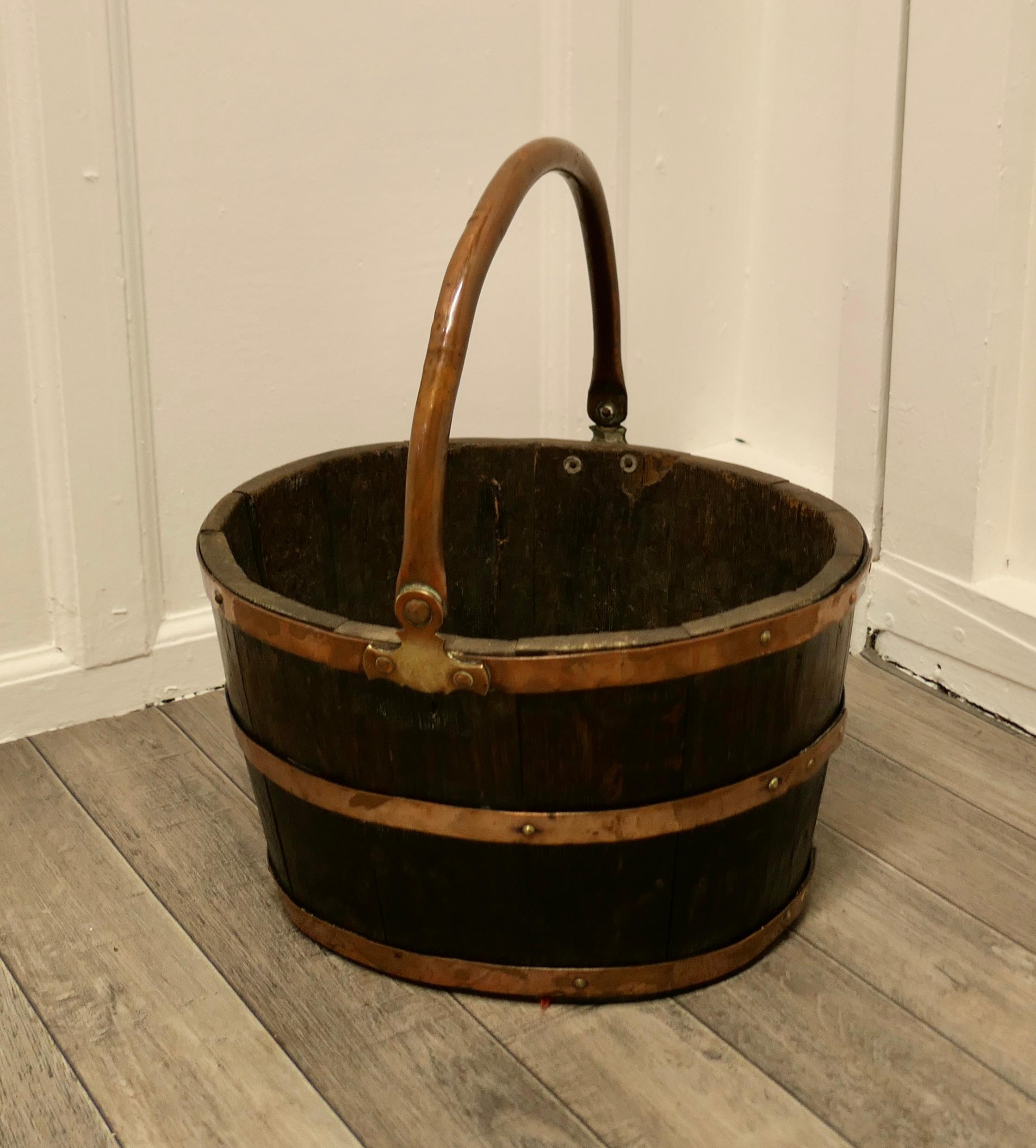 Copper and oak bucket for coal or logs

A superb coopered Oak barrel for Coal, the barrel is slightly oval in shape and has copper banding with a swing handle which allows it to be carried like a traditional coal bucket 
This is a very good