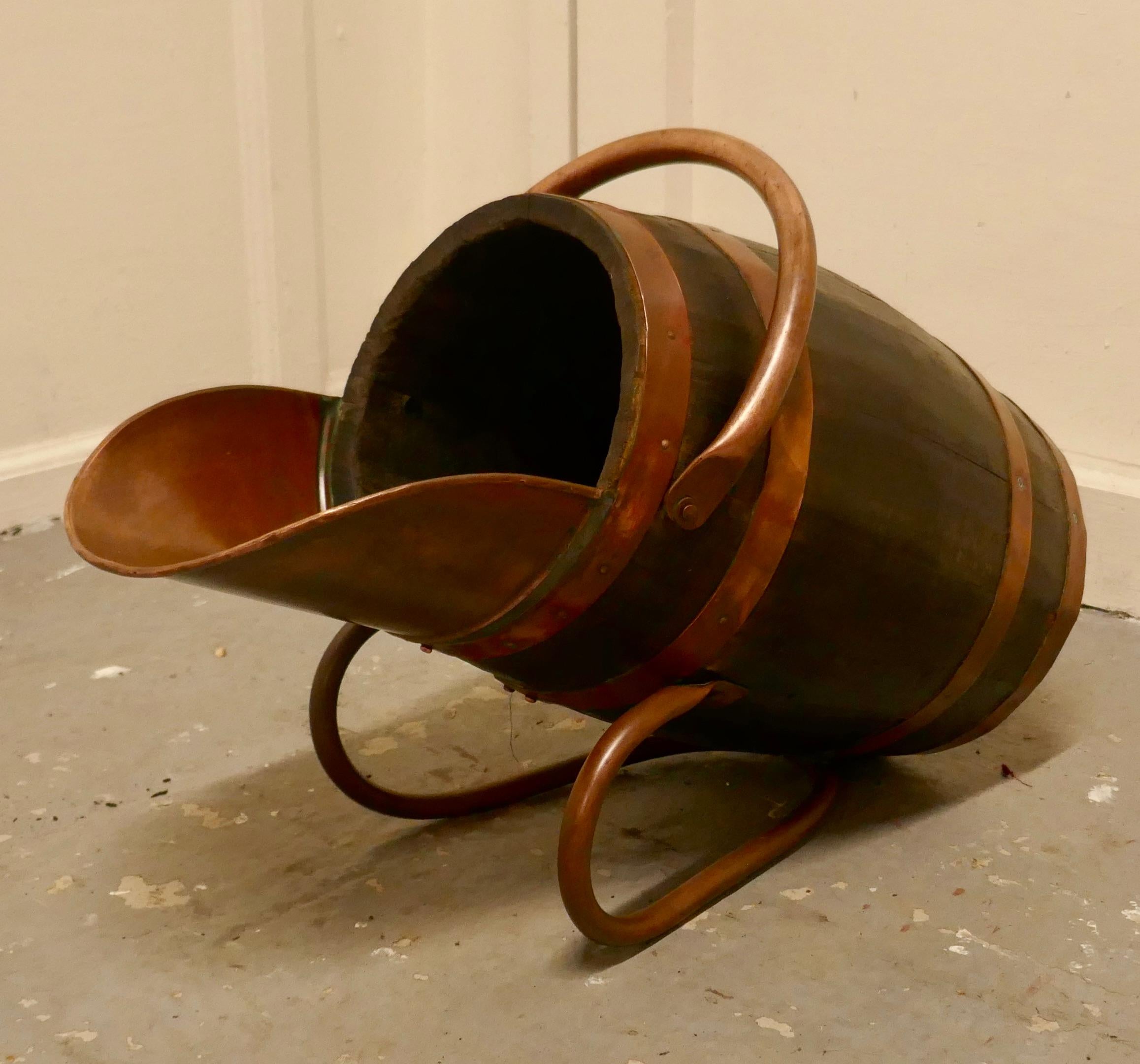 Copper and oak bucket/hod for coal

A superb coopered oak barrel for coal, the barrel has copper bands with copper sleigh type feet and a swing handle which allows it to used either as a traditional coal bucket or of carried upright as a coal