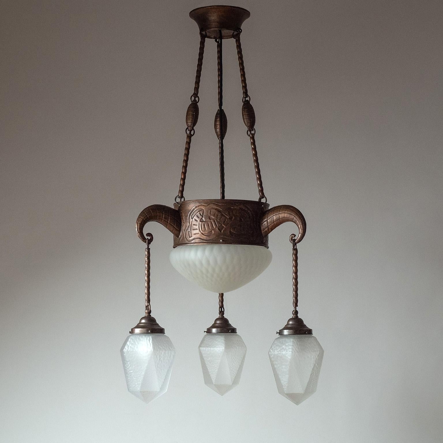 Rare German Jugendstil copper and glass suspension chandelier from the early 20th century. Copper-plated steel structure, embossed with ornate details, and delicate textured satin glass diffusers. Very nice original condition with minimal patina.