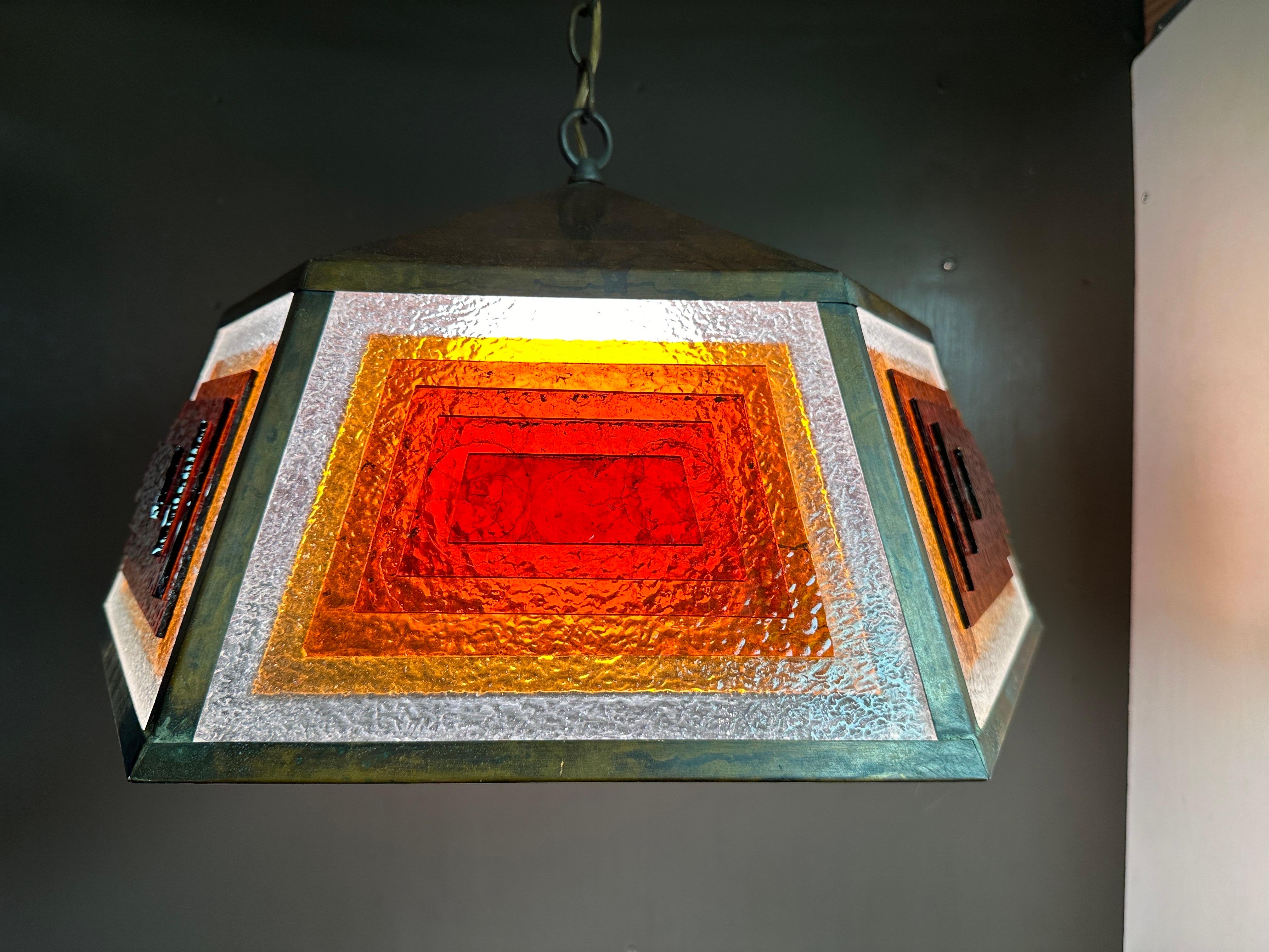 Patinated copper and stained glass light fixture / pendant in the manner of Frank Lloyd Wright in Arts and Crafts style. Requires one up to 60watt bulb. Chain is 60” and can be shortened.