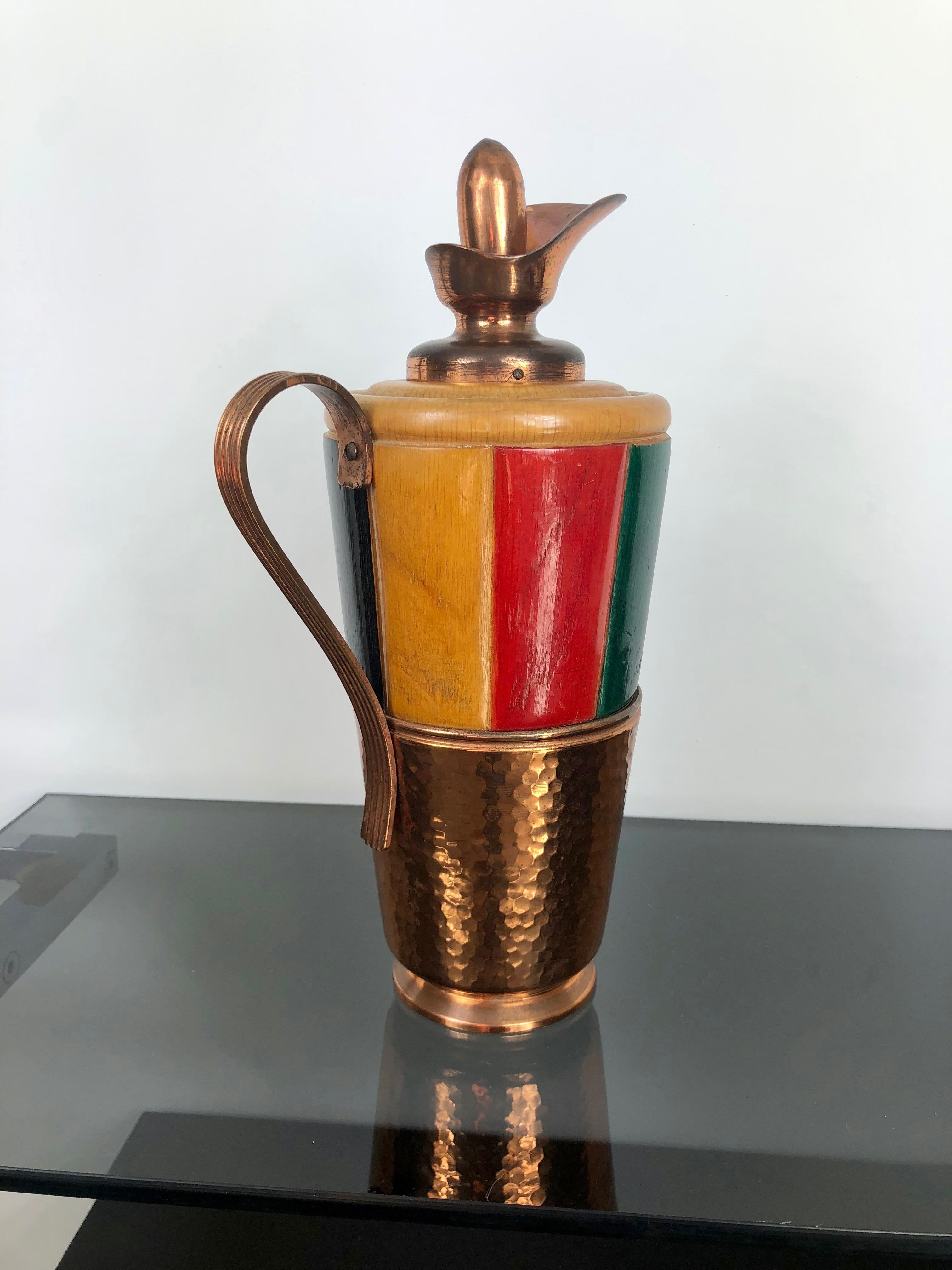 Thermos/decanter/pitcher by the Italian Aldo Tura for Macabo made of colored (red, green and black) wood and copper. 
The stamp is engraved on the bottom.