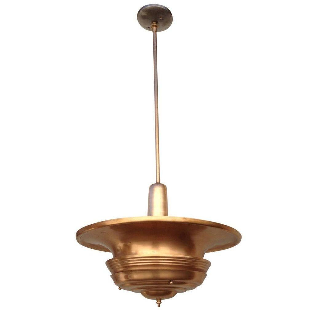 Art Deco era streamlined copper ceiling hanging pendant with a large copper saucer shade connected to a hanging stem.

America, circa 1930. the pole can be shortened. Can be almost flush-mounted.

Dimensions of light are 19” high.

Drop can be