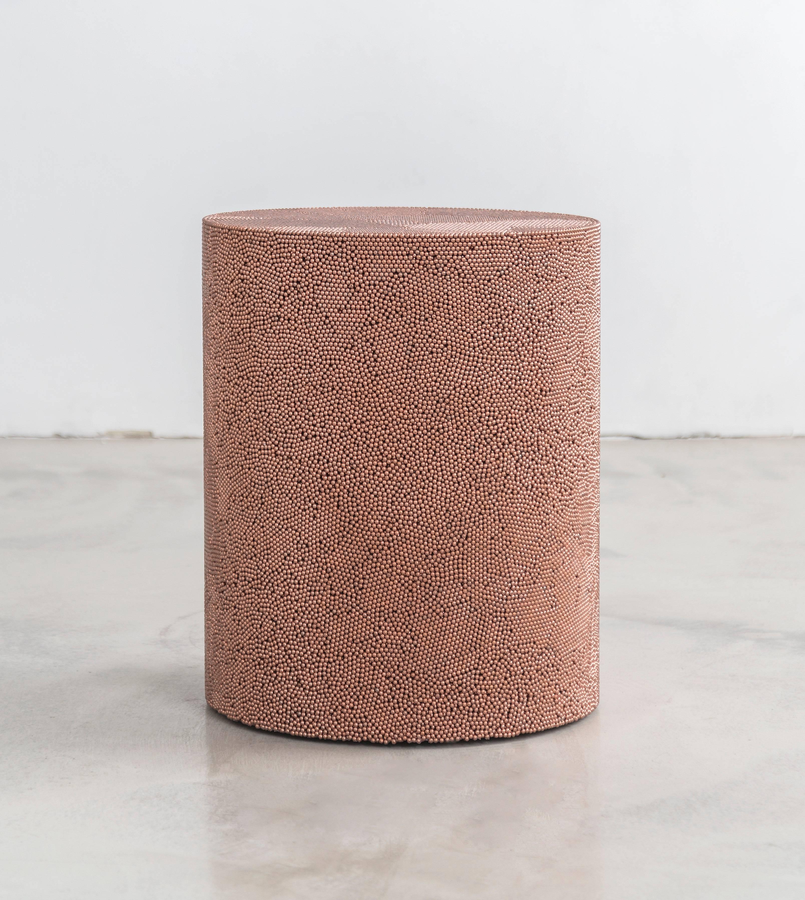 Composed from copper BB pellets, this made-to-order drum has a hollow cavity and consists fully of copper ammunition, creating a hypnotic camouflage of texture and smoothness. The piece has a hollow cavity and weighs approximately 90lbs.