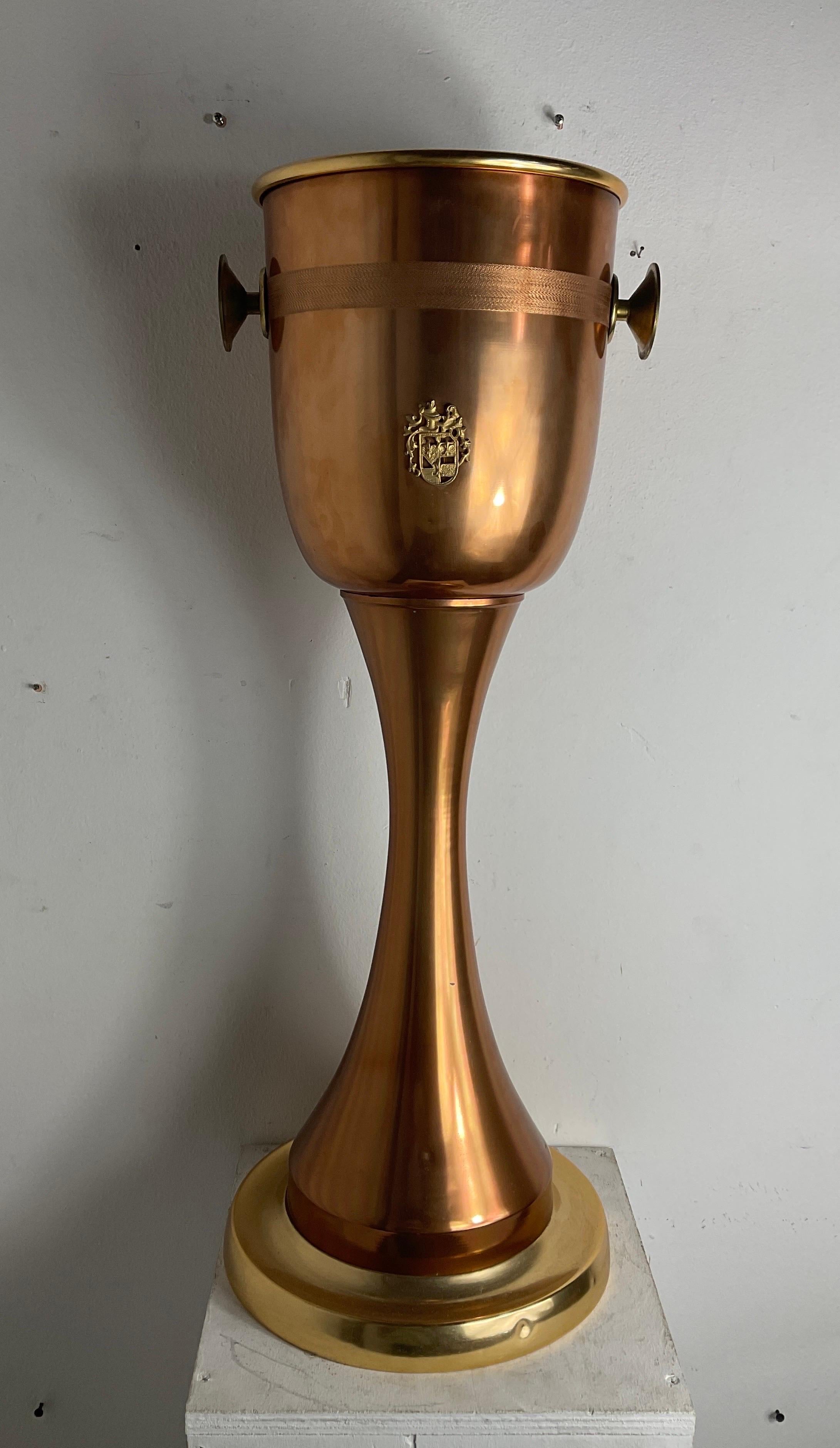 Copper bottle racks from the 80s. With a coat of arms in the centre of it, two side brass handles and in good condition with small wear and tear caused by years and use