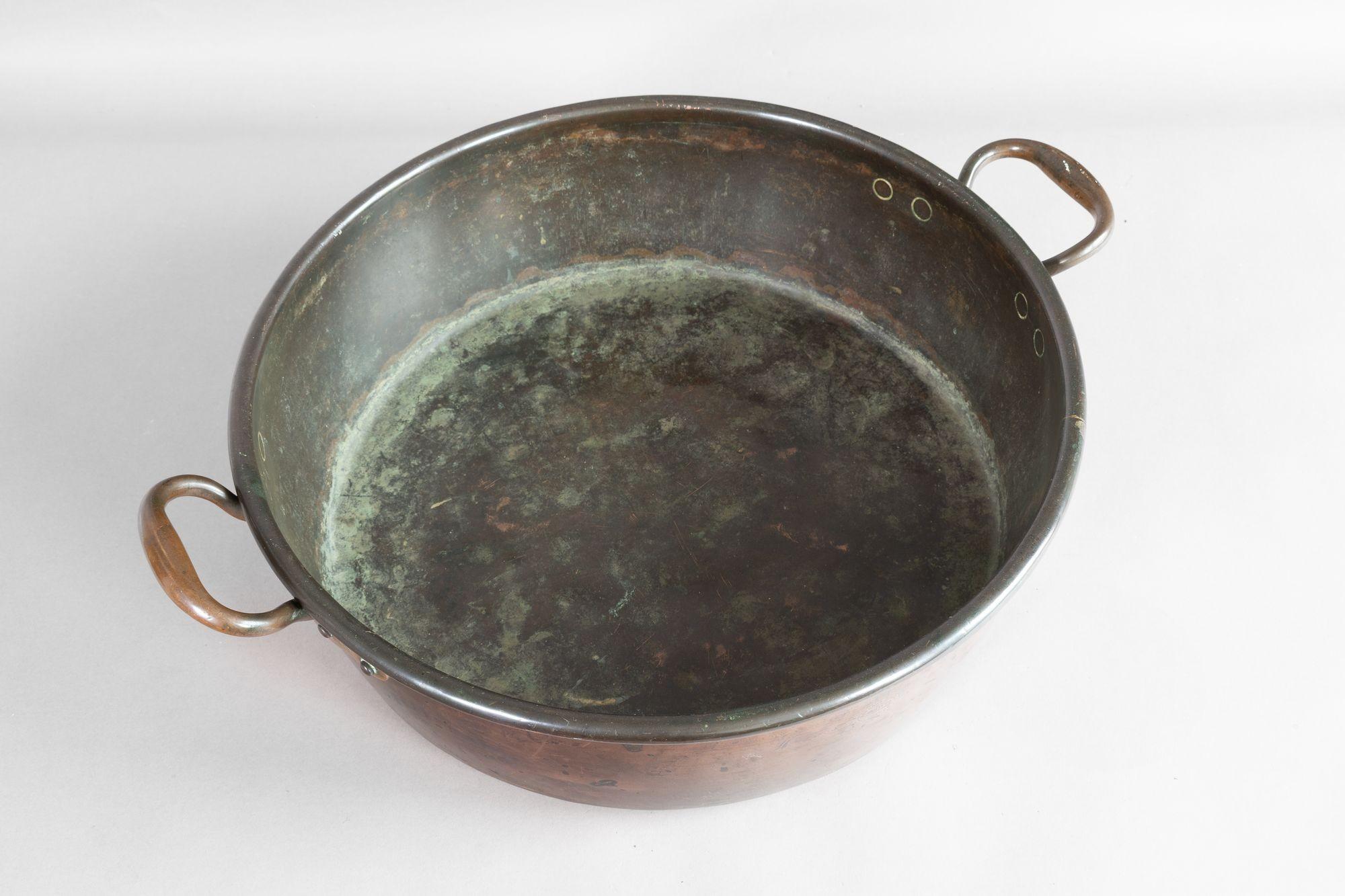 Large copper bowl with two brass carrying handles. Circa 1850.

H 15cm x W 60cm x D 48cm