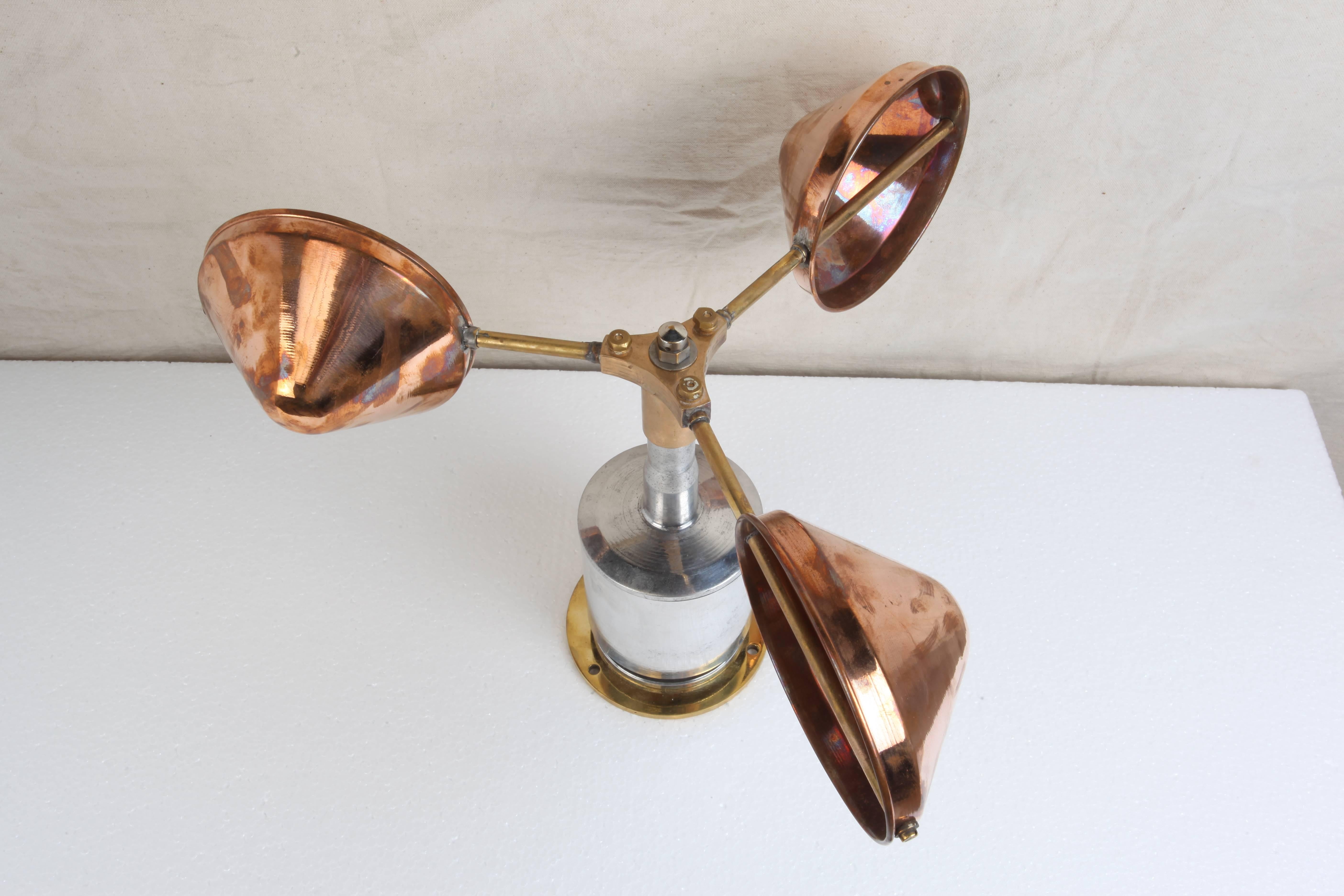 A functional ship's anemometer, used in measuring wind speed. Made of copper, brass and chrome. Can be used outside or in and the copper cups move freely. Polished and salvaged from decommissioned ships. Measure: Base is 5 inch diameter.