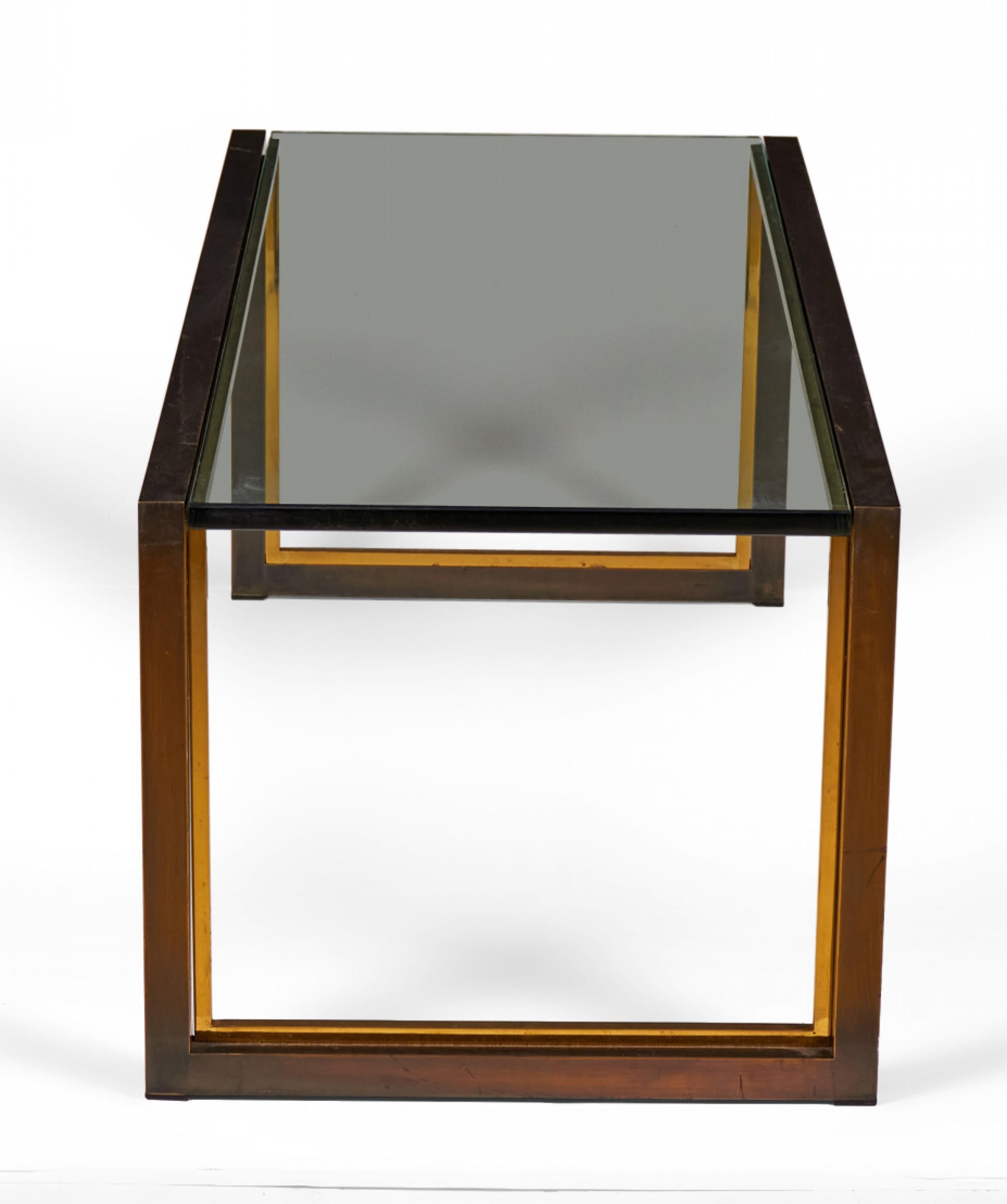 American Mid-Century rectangular coffee / cocktail table with a copper-colored metal bracket-shaped base with bronze trim and an inset smoked glass top.