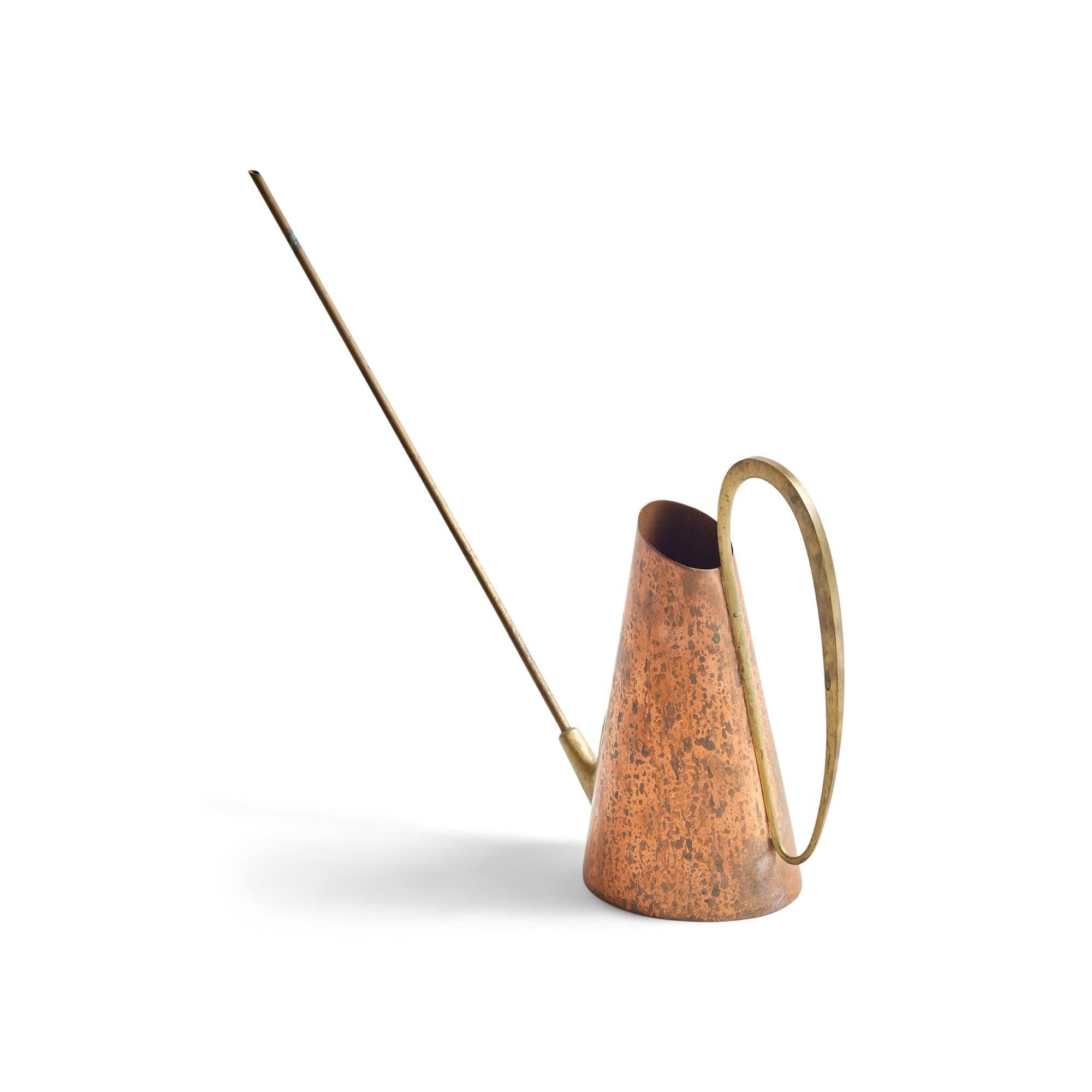 A brass and copper watering can.
