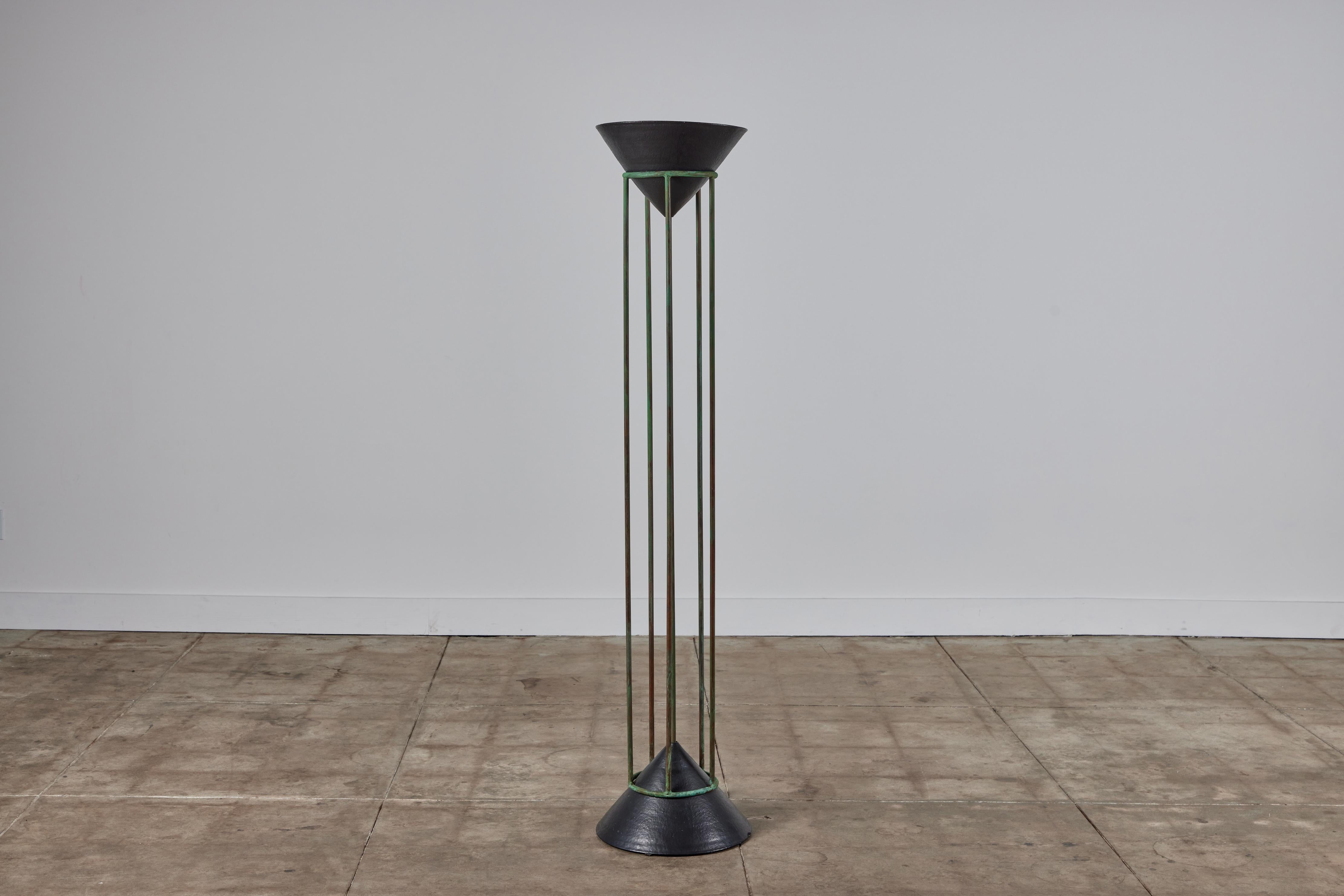 Postmodern copper and ceramic floor lamp, c.1987, USA. This lamp features a black glazed ceramic cone base as well as a ceramic shade with up lighting. The frame of the lamp is patinated copper tubing mimicking the style of Walter