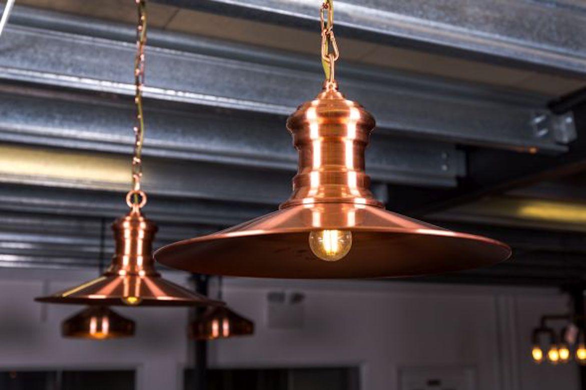 A fine copper colored flat pendant light, 20th century. 

This industrial style flat pendant light comes from a lovely collection of rose gold colored lighting.

Although they are priced individually, the lights can be purchased in a larger
