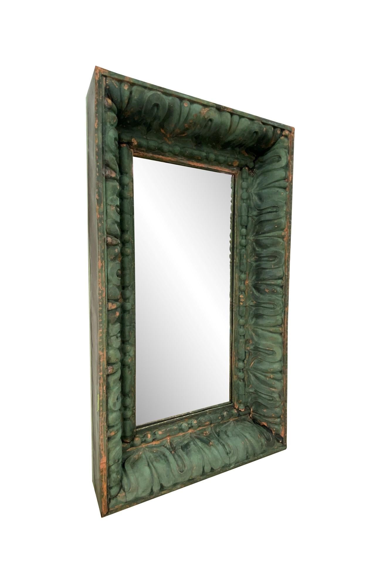 This large scale mirror is made from a turn of the century copper cornice from a NYC building. Features a stylized egg and dart design which dates back to ancient Greece. Original natural weathered verdigris patina. New mirror glass. Full wood