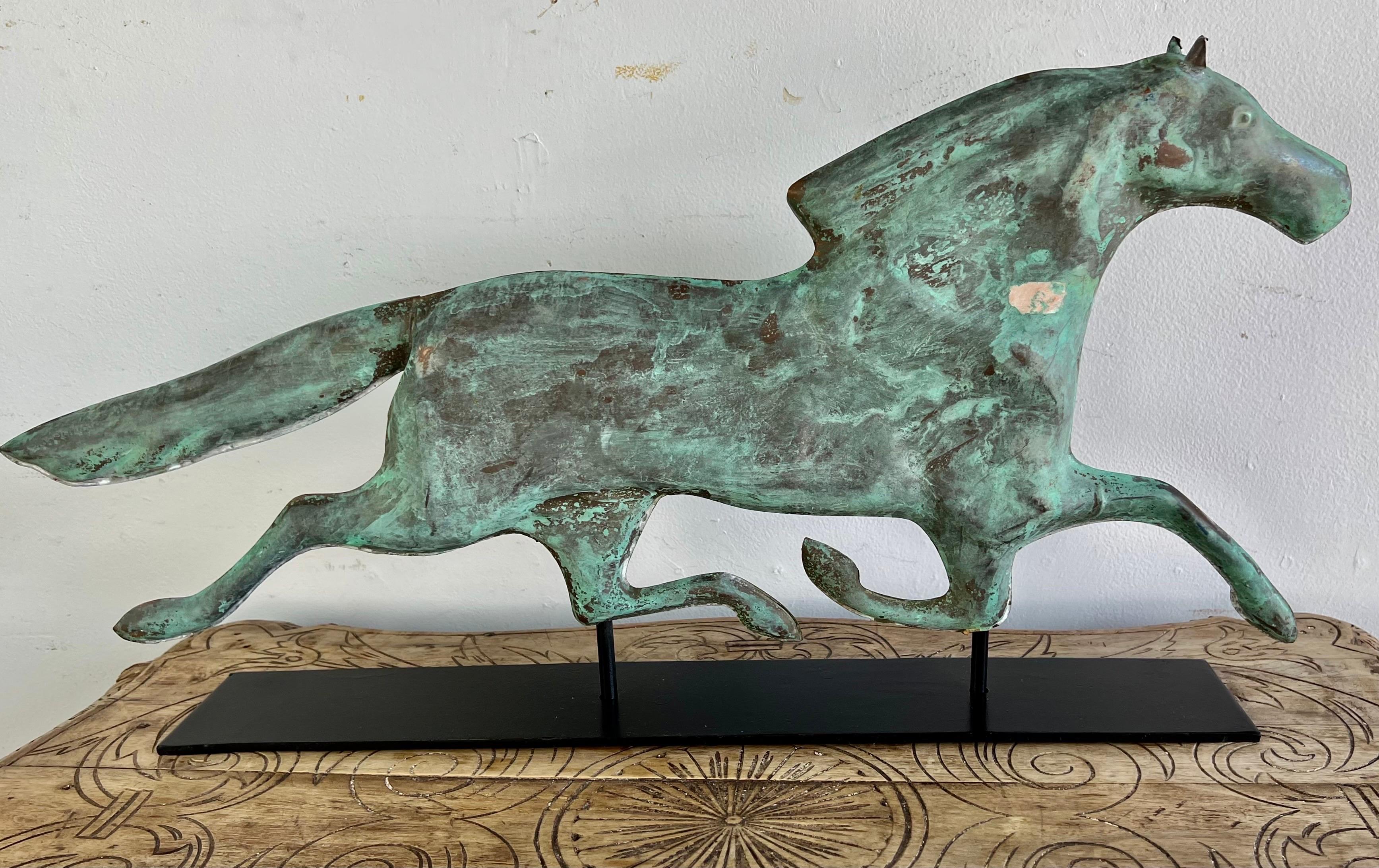 Early 20th century copper Dexter Horse that came off a vintage weathervane. We mounted the horse, with it's stunning greenish blue finish, on an iron base for easy display.