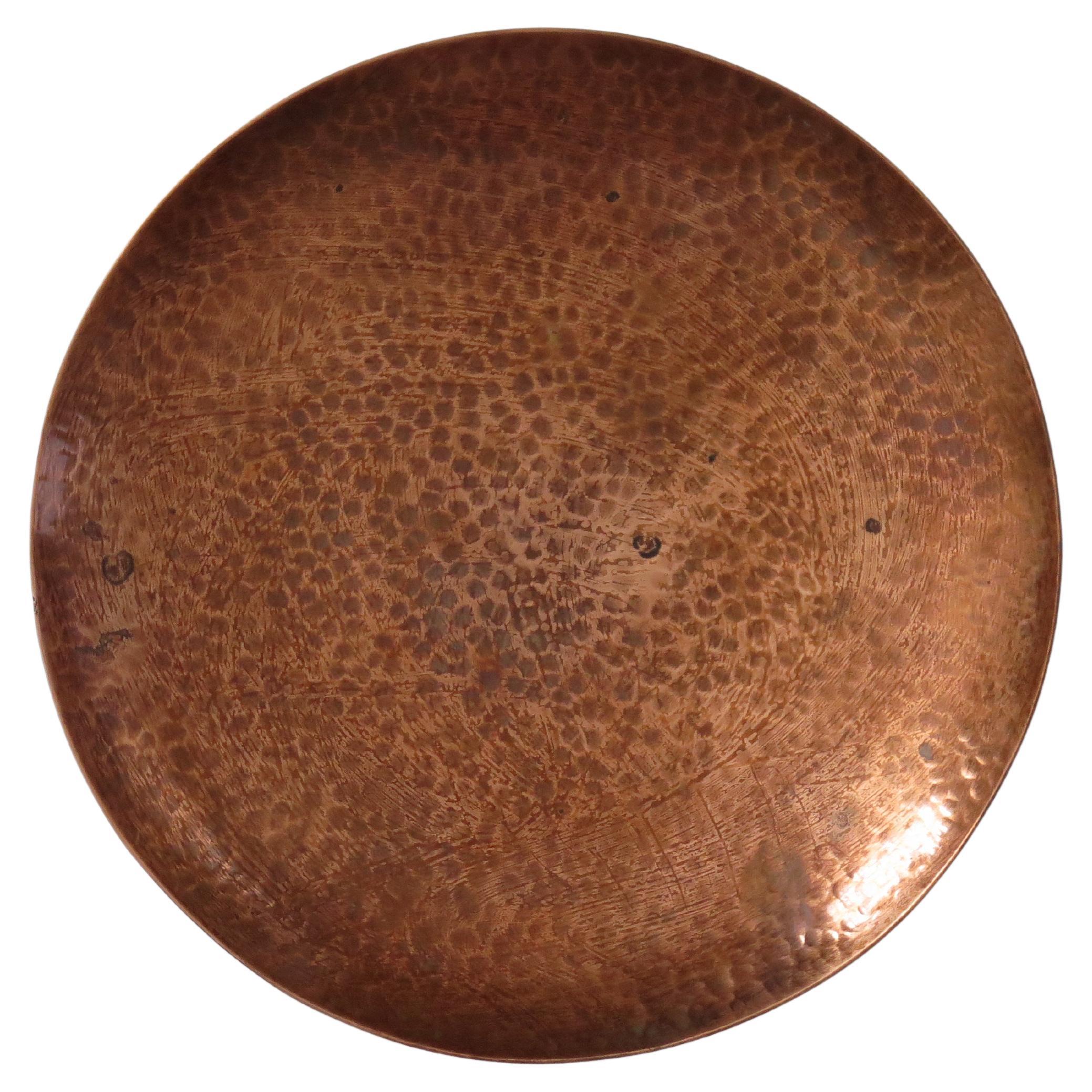 This is a hand made, hammered copper dish made by Harold Barnes an English Yorkshire coppersmith, all in the Arts and Crafts style and dating to the mid 20th Century.

The dish is made of finely hand planished copper and sits on three small bun