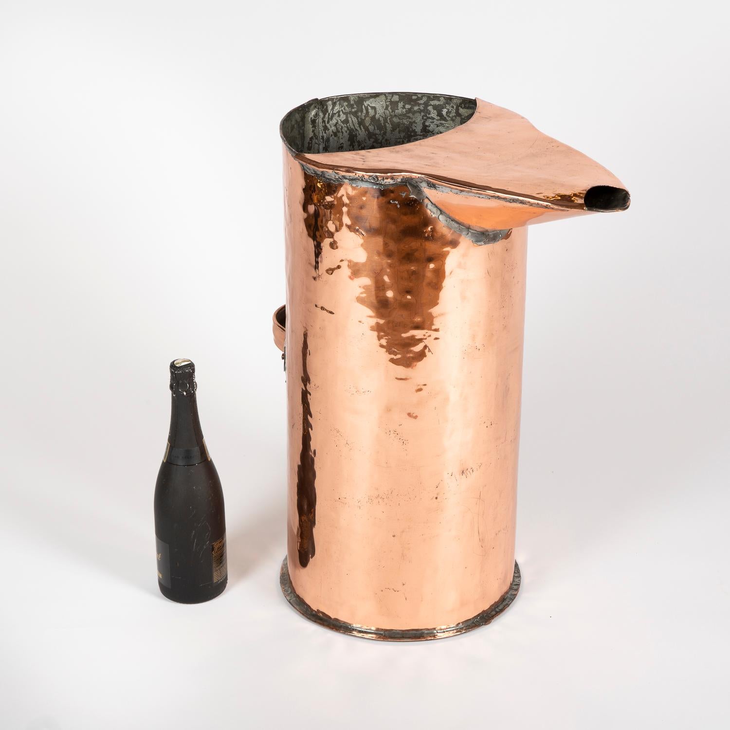 A large late 19th century copper distiller's jug from the Calvados in the Normandy region of northwest France.

Measure: Height 61 cm.