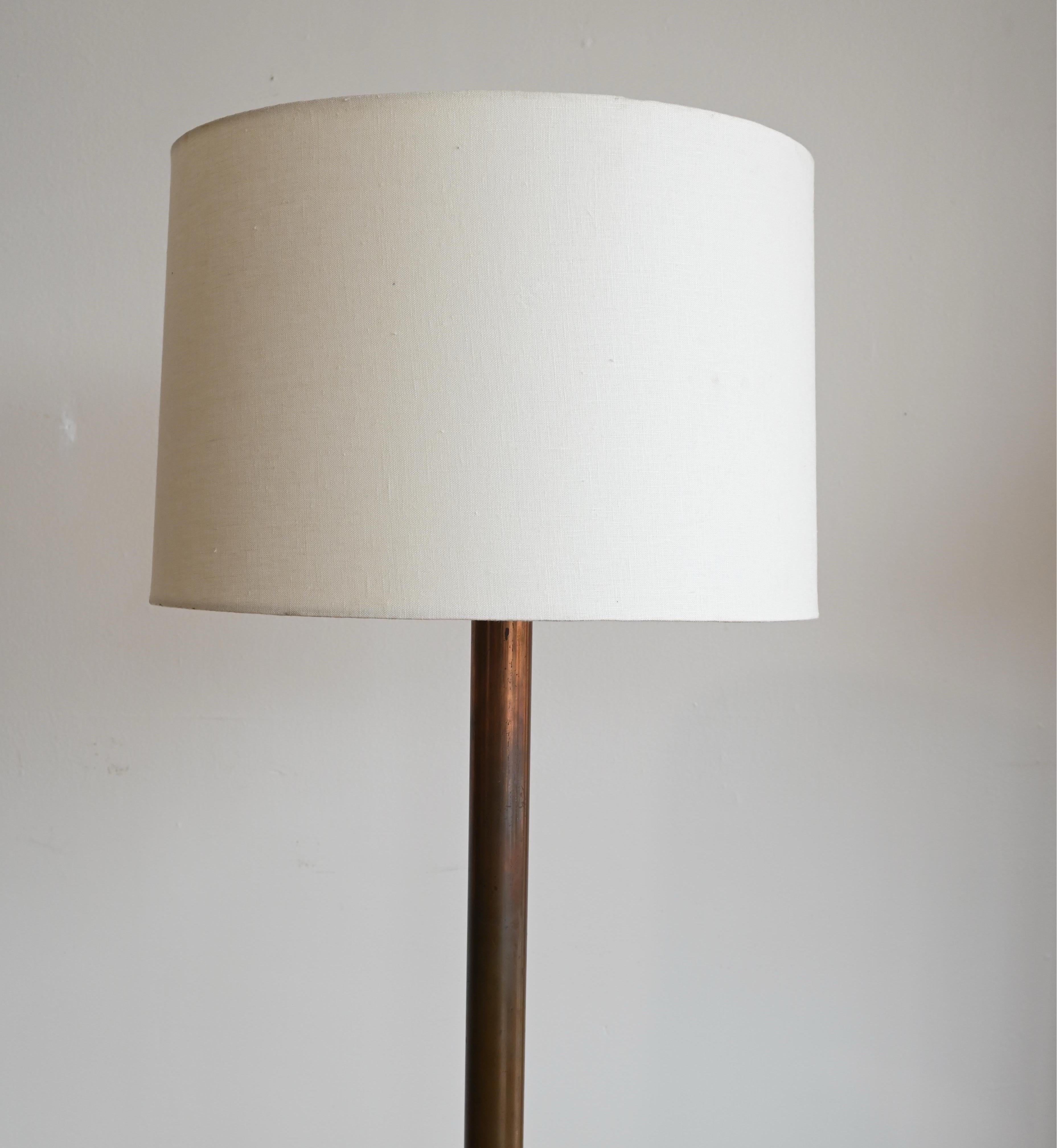 A solid copper floor lamp with tons of character and natural patina. A truly gorgeous piece with a contemporary high-end linen drum shade.