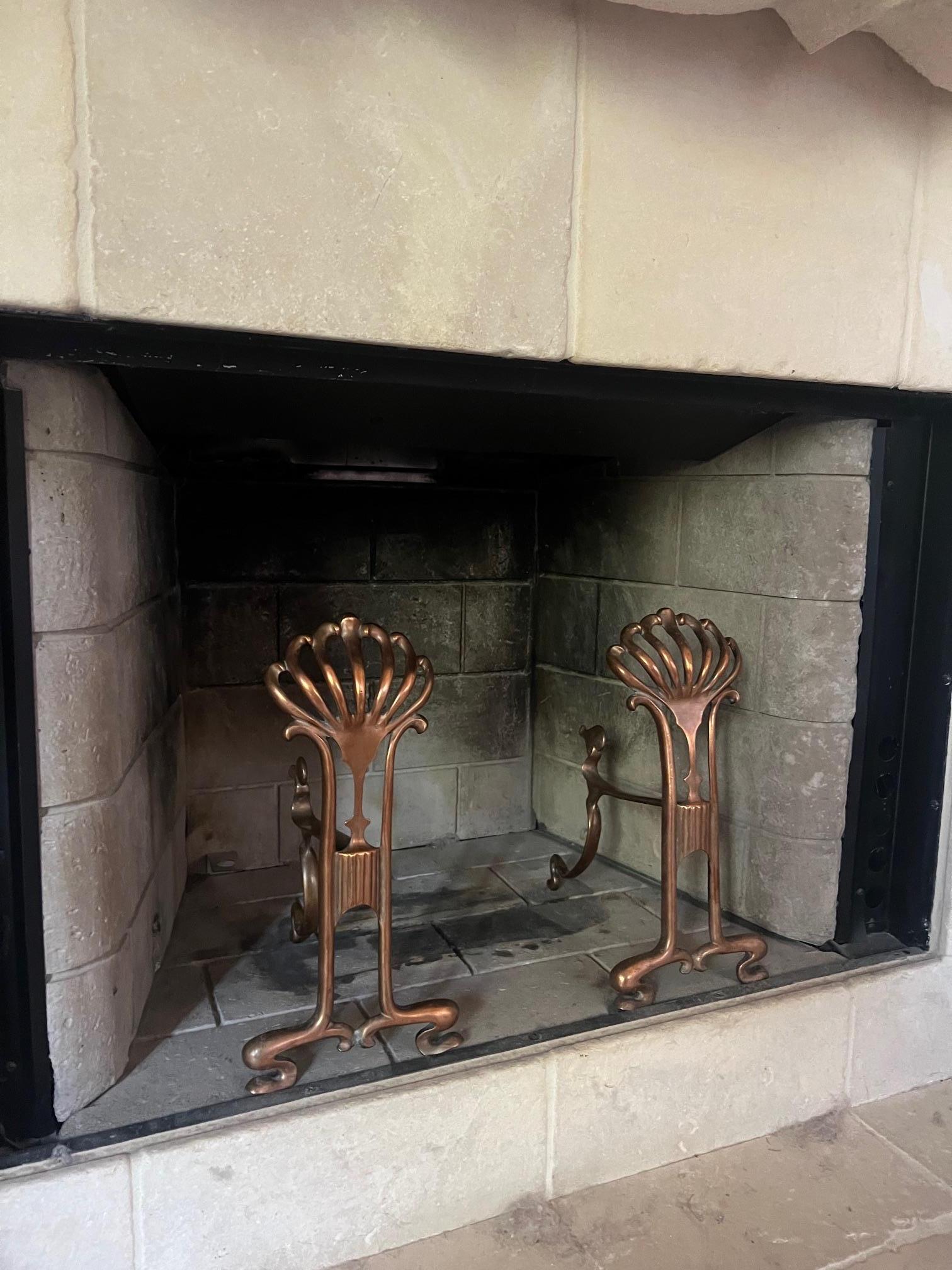 Cast copper andiron set in the Art Nouveau style, made in France around 1900.