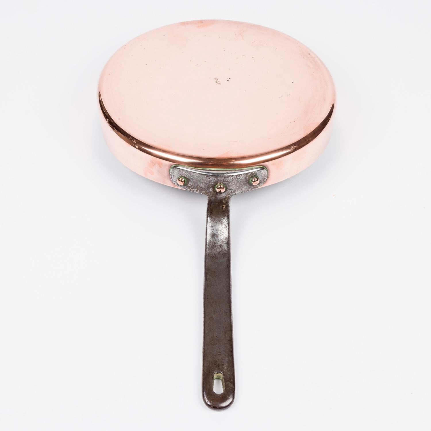 A late 19th century copper sauté pan by Benham & Froud of London, circa 1880.

Copper pan with tinned interior and riveted iron handle, with a hole for hanging.

Marked with the Benham & Froud Cross and Orb stamp.

 

Benham & Froud, Chandos St,