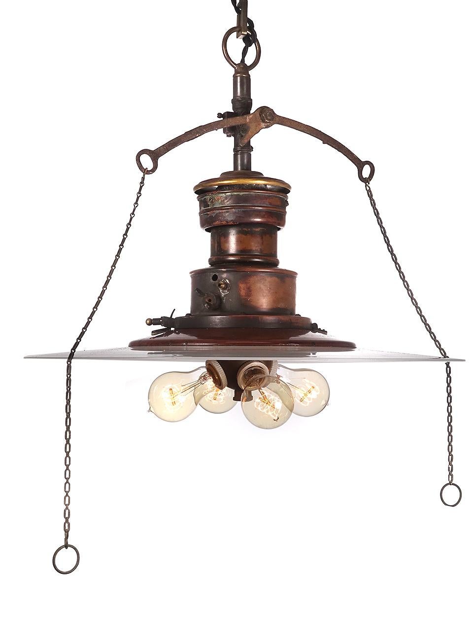 We love the look of this lamp. You just can't find hand blown 20 inch flat milk glass disk shades anymore. The shade featured on this lamp is very flat and that is desirable. It also has a rare 4 bulb Benjamin bulb cluster. The lamp is all copper