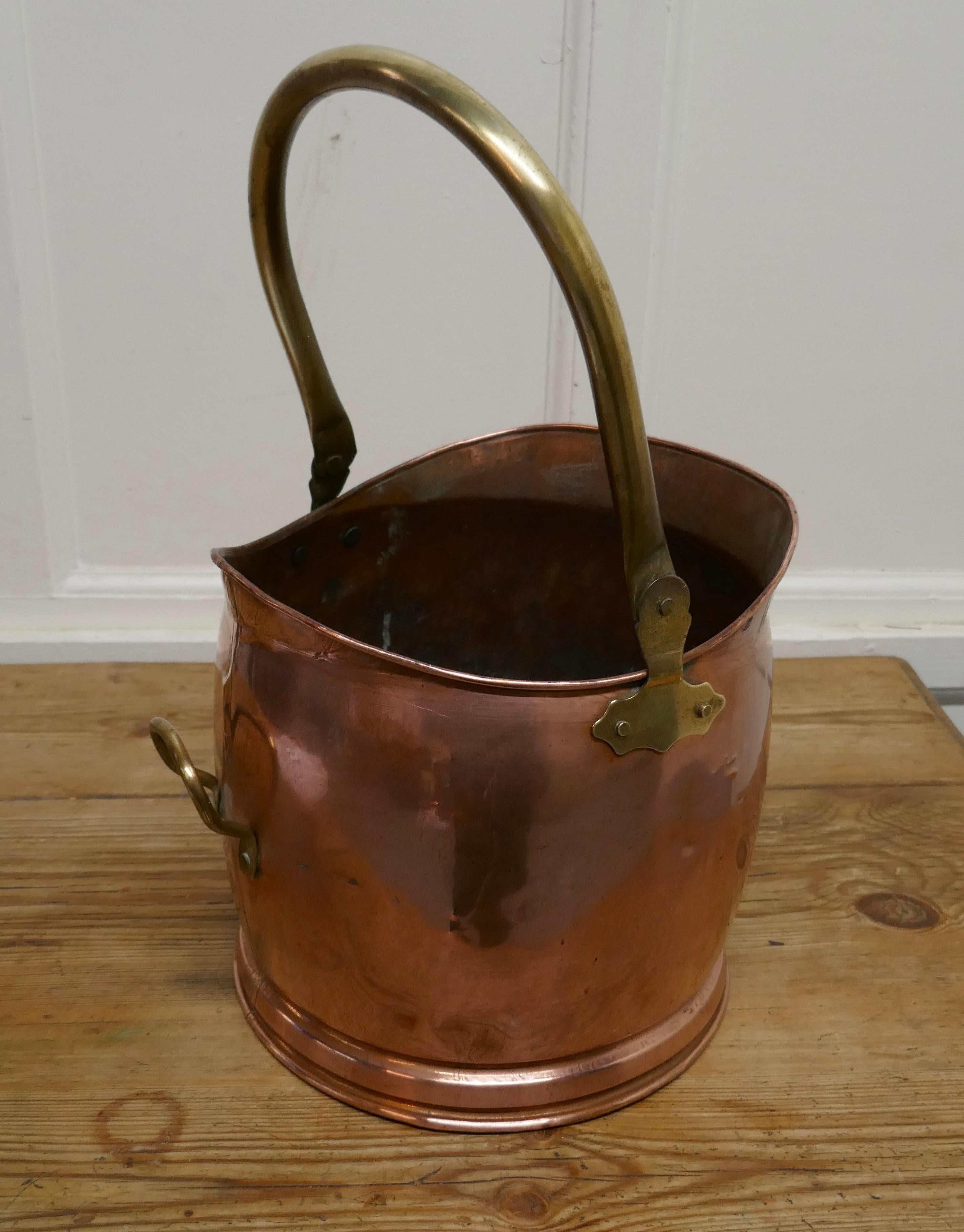 Copper Helmet Coal Scuttle

This bucket is a very attractive helmet shape, it is made in beaten copper with riveted hooped brass handles
The scuttle is in good used condition, it has no faults just lots of character and is ready to go to work and