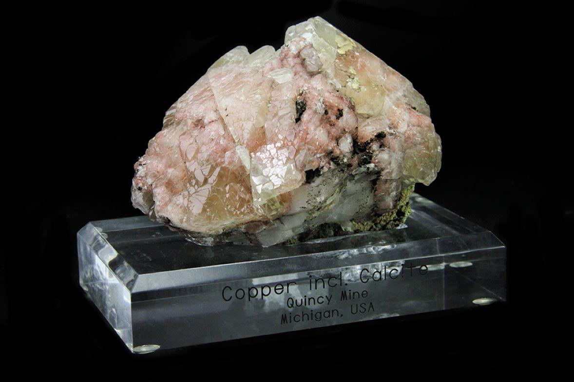 From Quincy Mine, Hancock, Keweenaw Peninsula Copper District, Houghton County, Michigan

Lustrous translucent parallel scalenohedral calcite crystals with metallic copper inclusions on matrix. The copper inclusions are visible throughout the