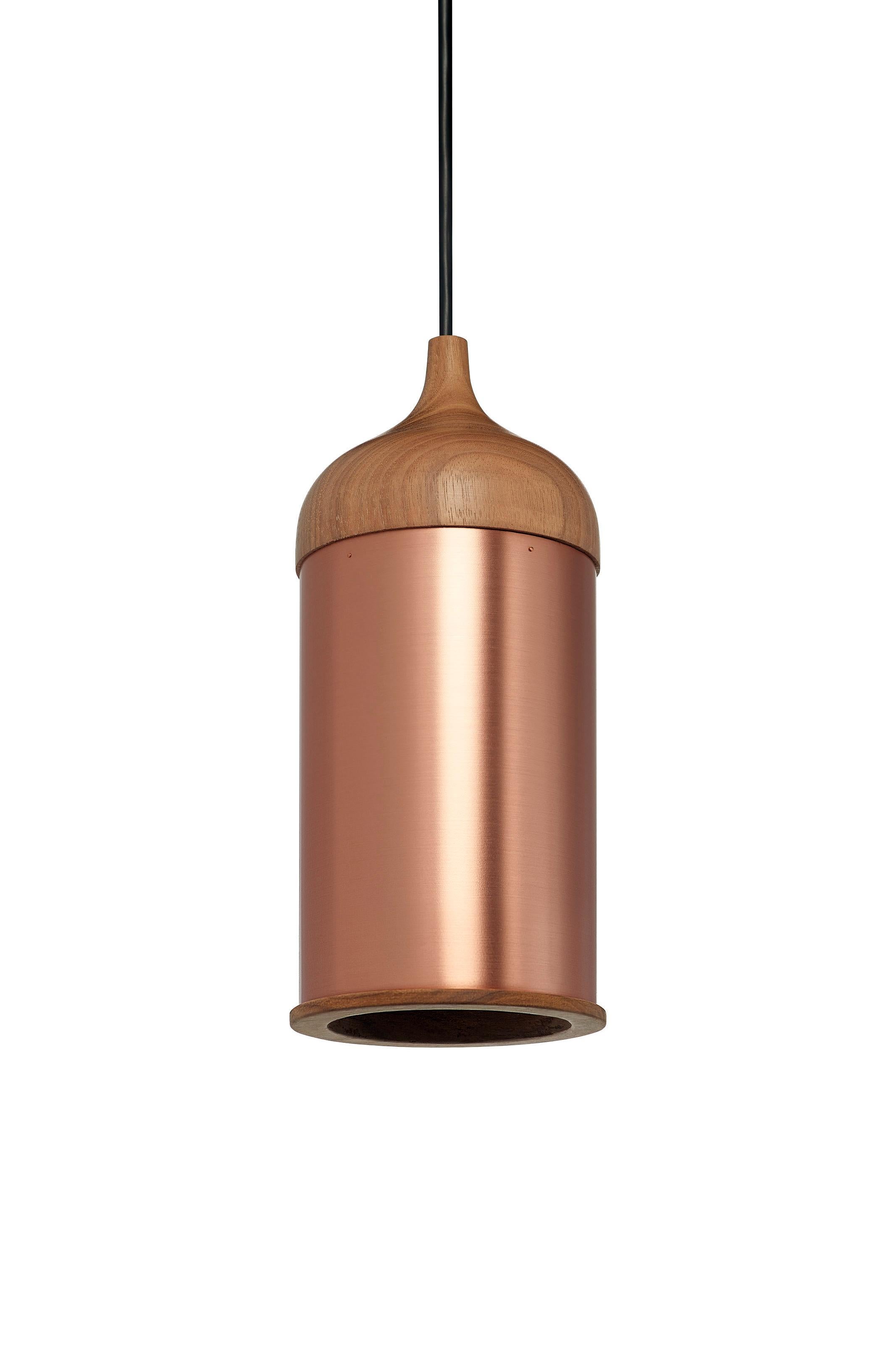A cool led light reflects inside the copper pendant lamp. It creates a clear light center which is surrounded by a warm copper semblance. Walnut parts fits precisely in the ends of the copper tube. The parts are shaped on the same type of machine,