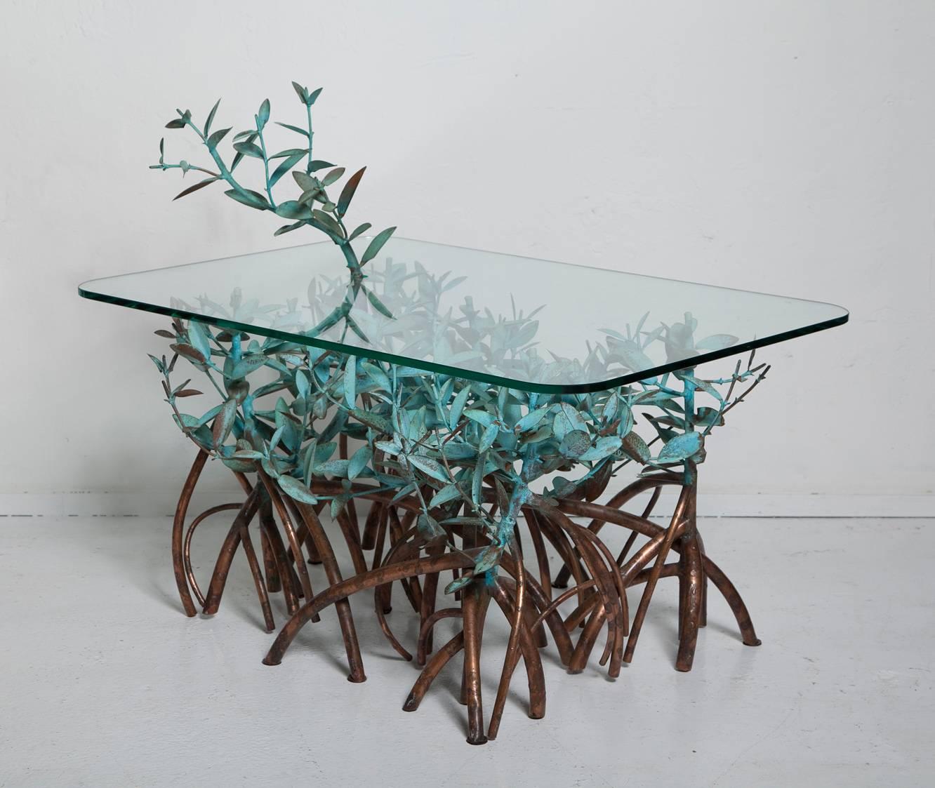 If you frequent South Florida or the Caribbean, you'll recognize the ubiquitous mangrove trees that serve as inspiration for this wonderful hand-wrought and patinated copper coffee table by Garland Faulkner, circa 1960. The tabletop measures 20.5