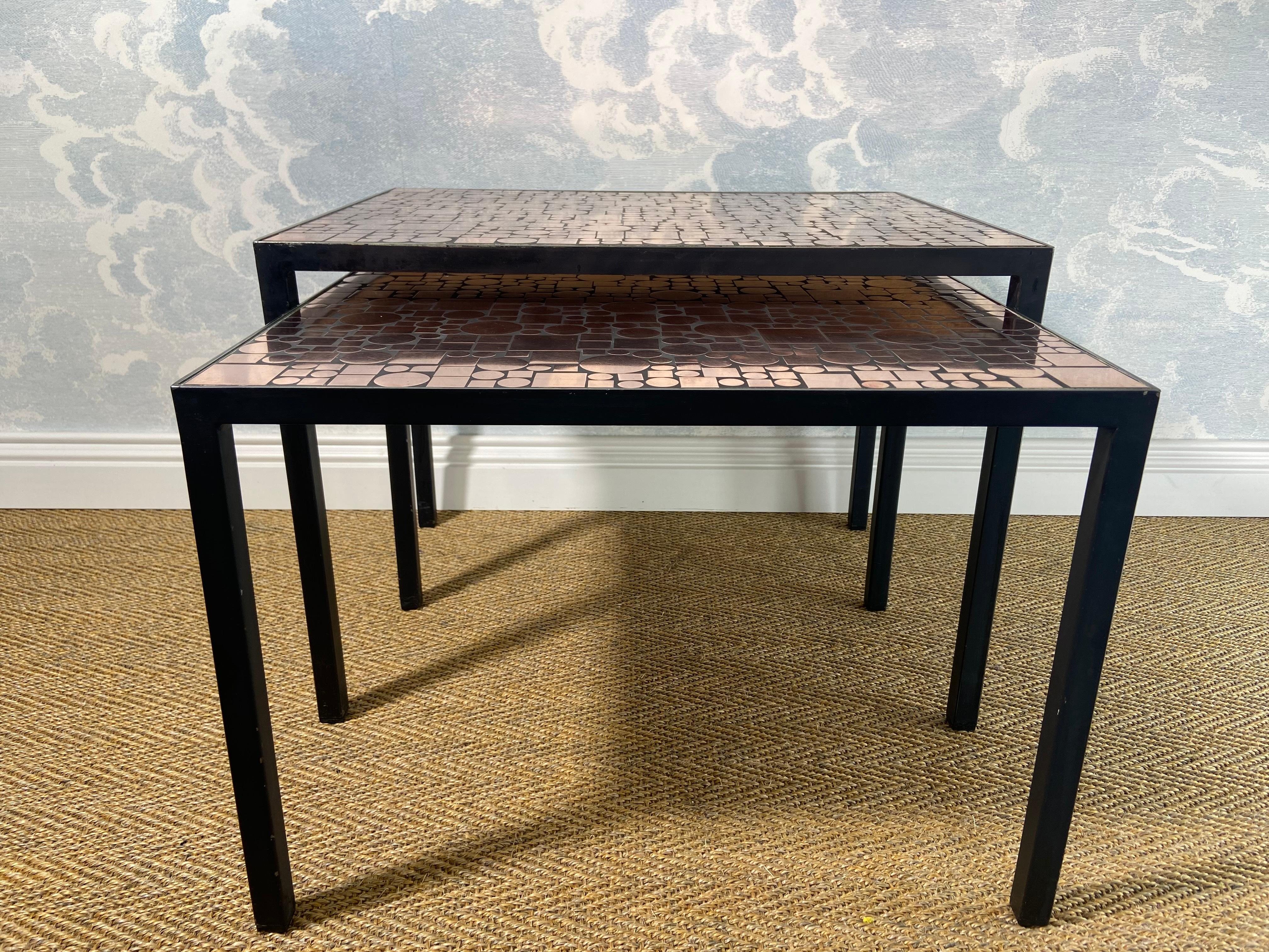 This rare set of two tables by Herbert Hirche is based on a 1956 design for Christian Holzäpfel and was produced in a very limited edition by Rosenthal in the 1970s.

The shiny table tops are composed of different sized copper circles and squares,