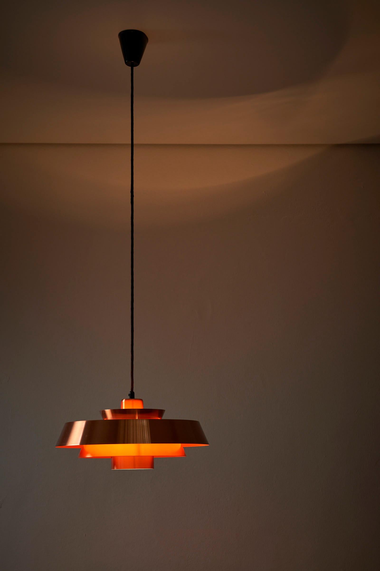 Introducing the exquisite Copper Nova Lamp, a true masterpiece designed by Jo Hammerborg for Fog&Mørup, hailing from Denmark. This extraordinary lamp showcases the timeless elegance and exceptional craftsmanship that are synonymous with Danish