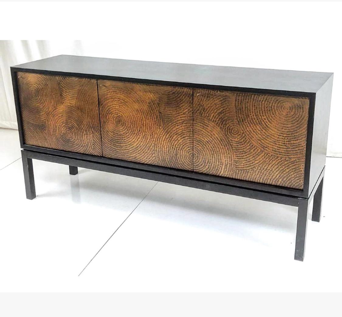 Magnificent modernist sideboard/credenza with ebonized cabinets featuring elaborate copper paneled doors. The cabinet sits on ebonized wooden legs.

Measures: 70 inches wide, 19 inches deep, 34 inches tall.